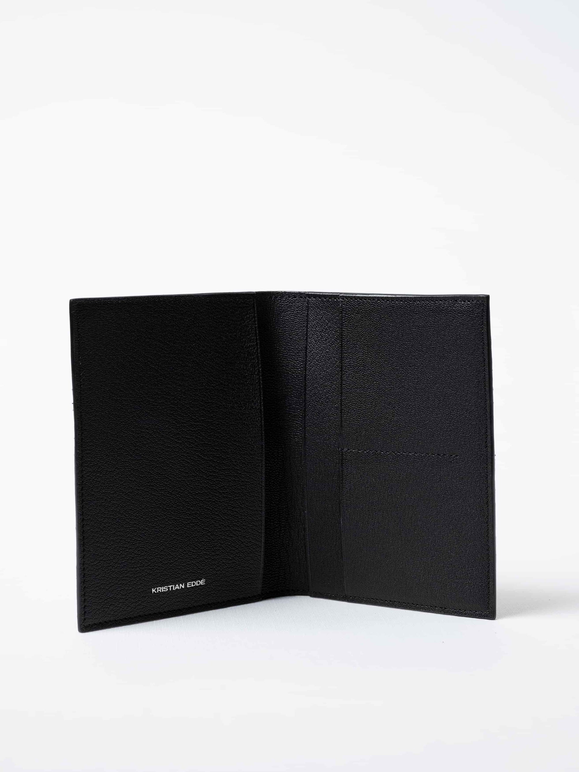 Vega luxury travel wallet in black fish leather, fully open to show interior compartments and the silver logo, sustainable luxury by Kristian Eddé