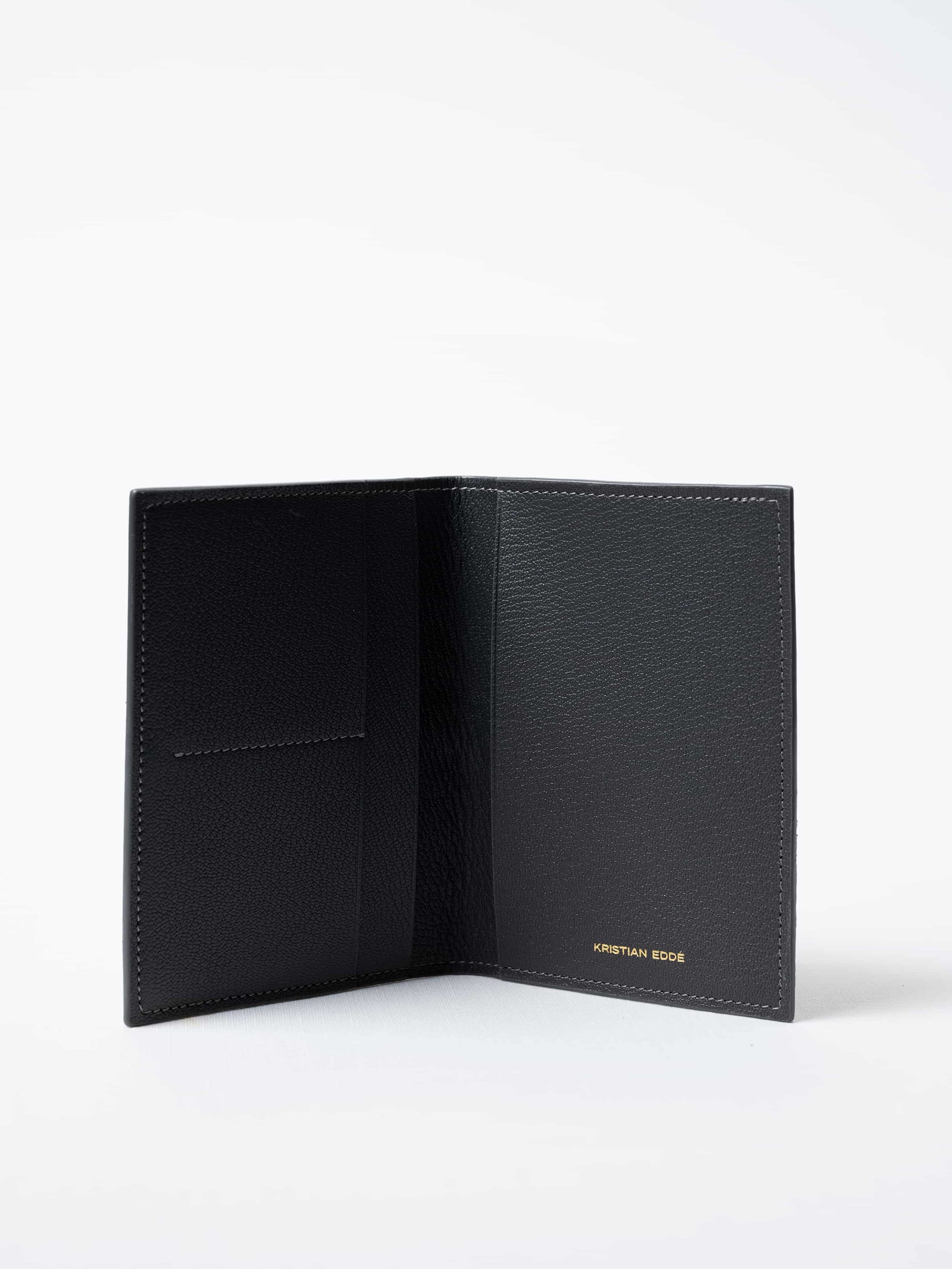 Vega Fold Passport Holder in gray fish leather, fully open to show interior compartments and gold logo, sustainable luxury by Kristian Eddé