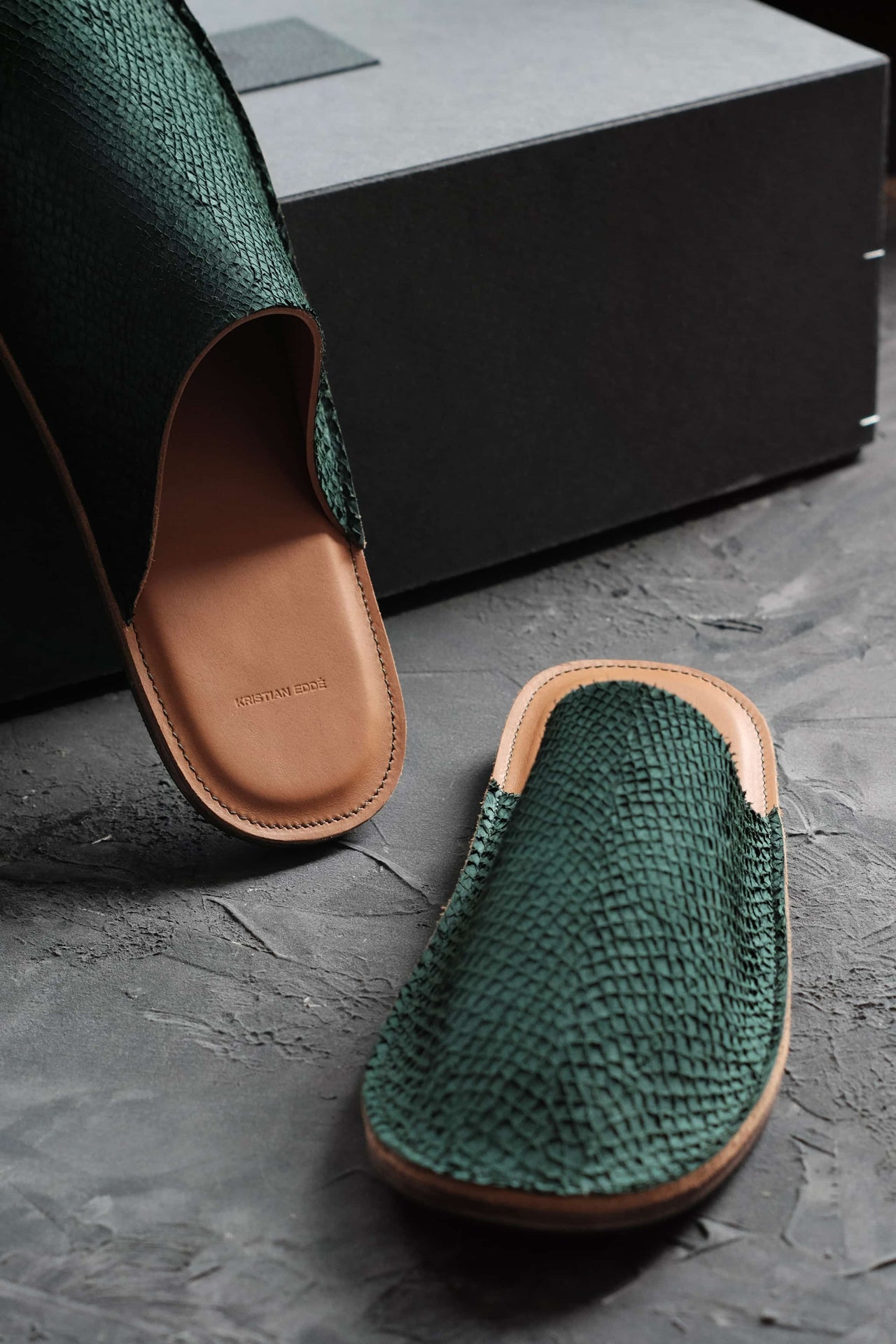 Green fish leather slipper with embossed logo on the heel, The Atelier Slipper by Kristian Edde