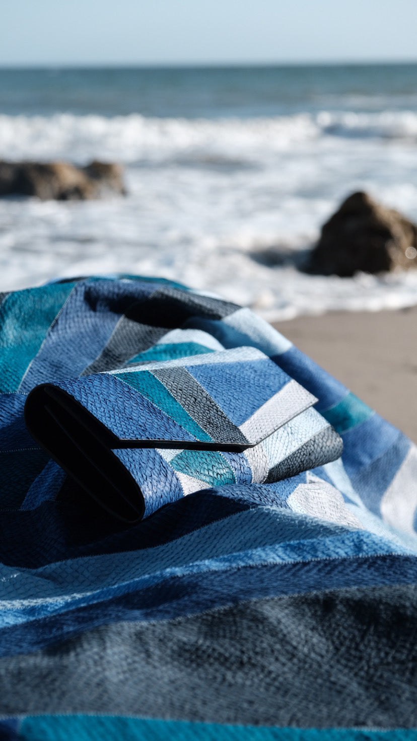 Handcrafted California Canvas material made from patchwork of 40 salmon leather pieces, forming a unique textured fish leather fabric used for luxury accessories by Kristian Eddé.