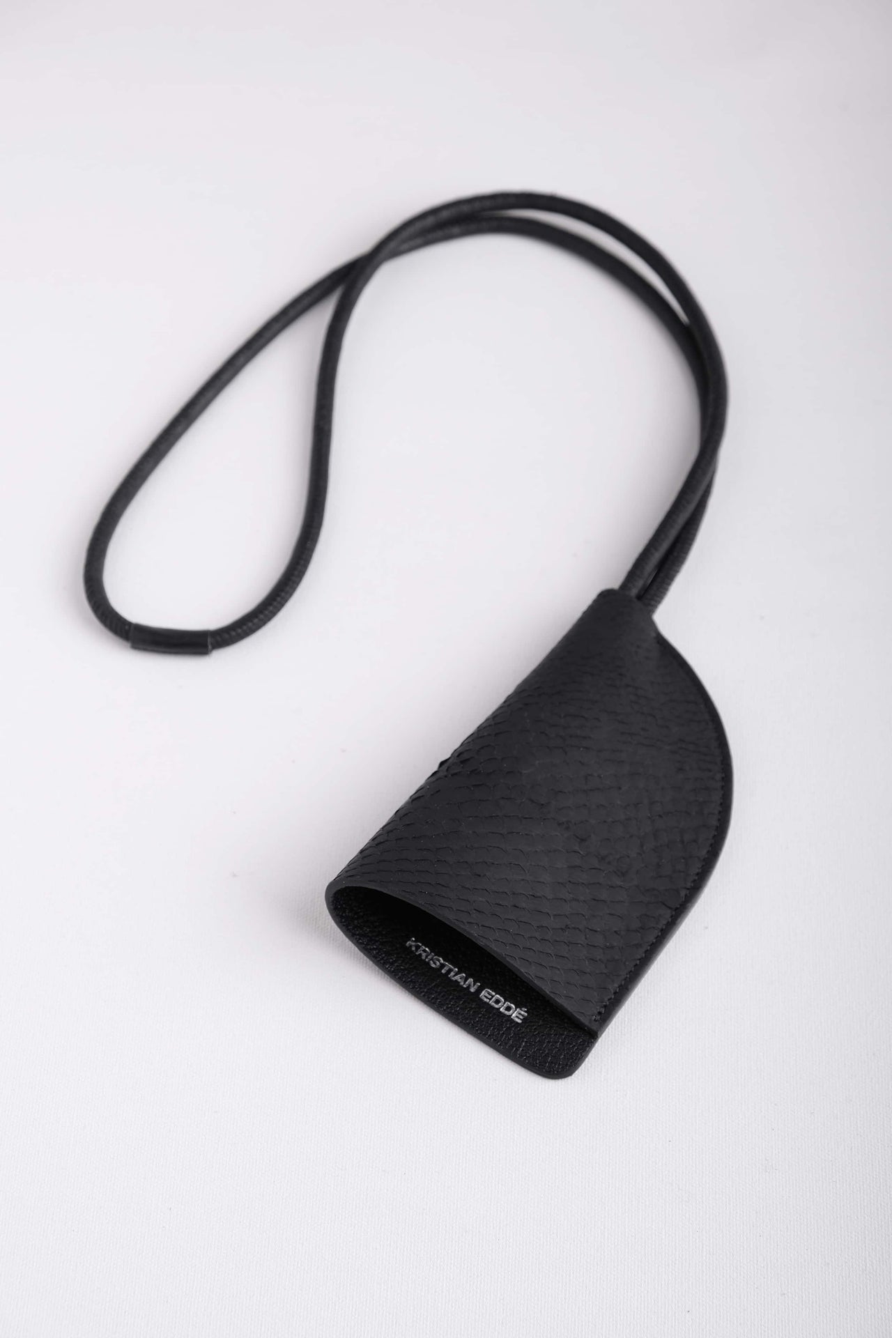 Front view of Fjord black fish leather round neck keychain with leather cord strap