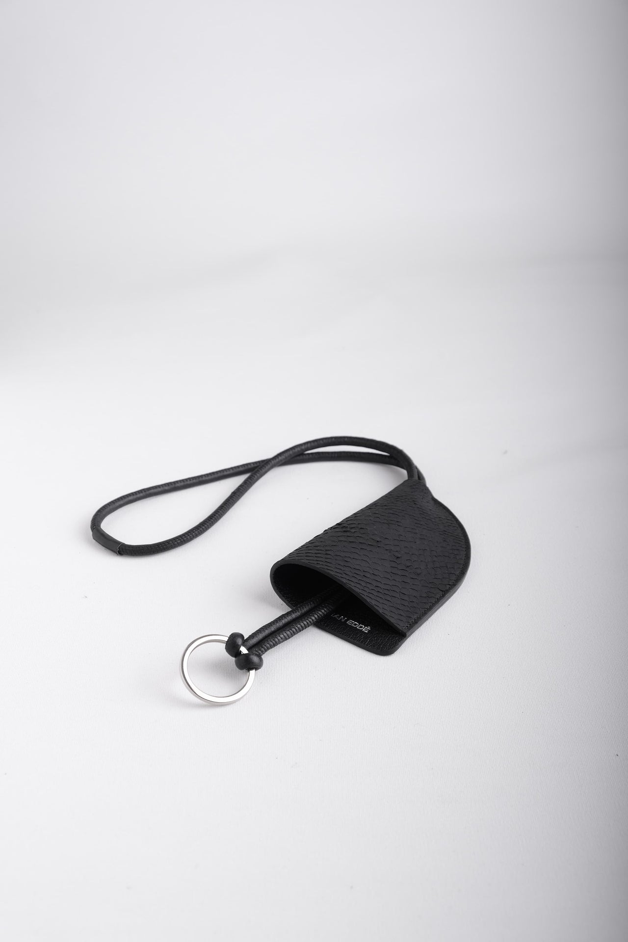 Fjord salmon leather round neck keychain in Arctic Black with leather cord strap and silver key ring