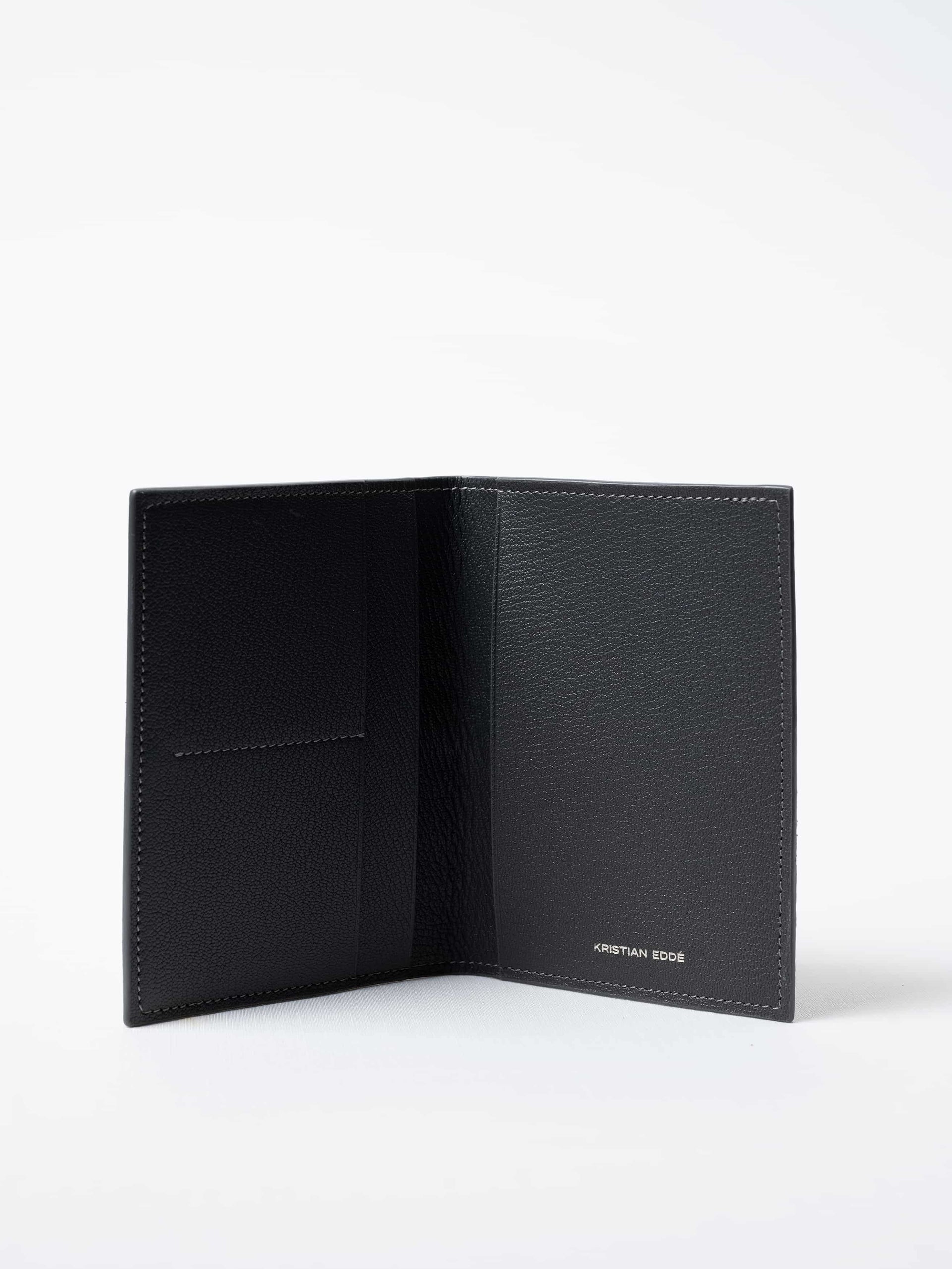 Vega luxury travel wallet in gray fish leather, fully open to show interior compartments and silver logo, sustainable luxury by Kristian Eddé
