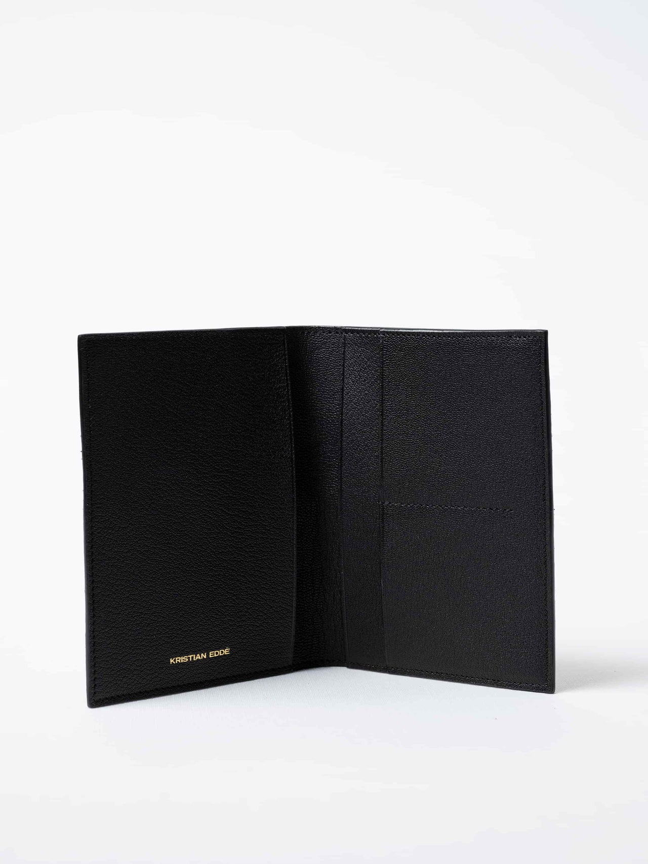 Trawler Fold Passport Holder in black salmon leather, fully open to show interior compartments and the golden logo, sustainable luxury by Kristian Eddé