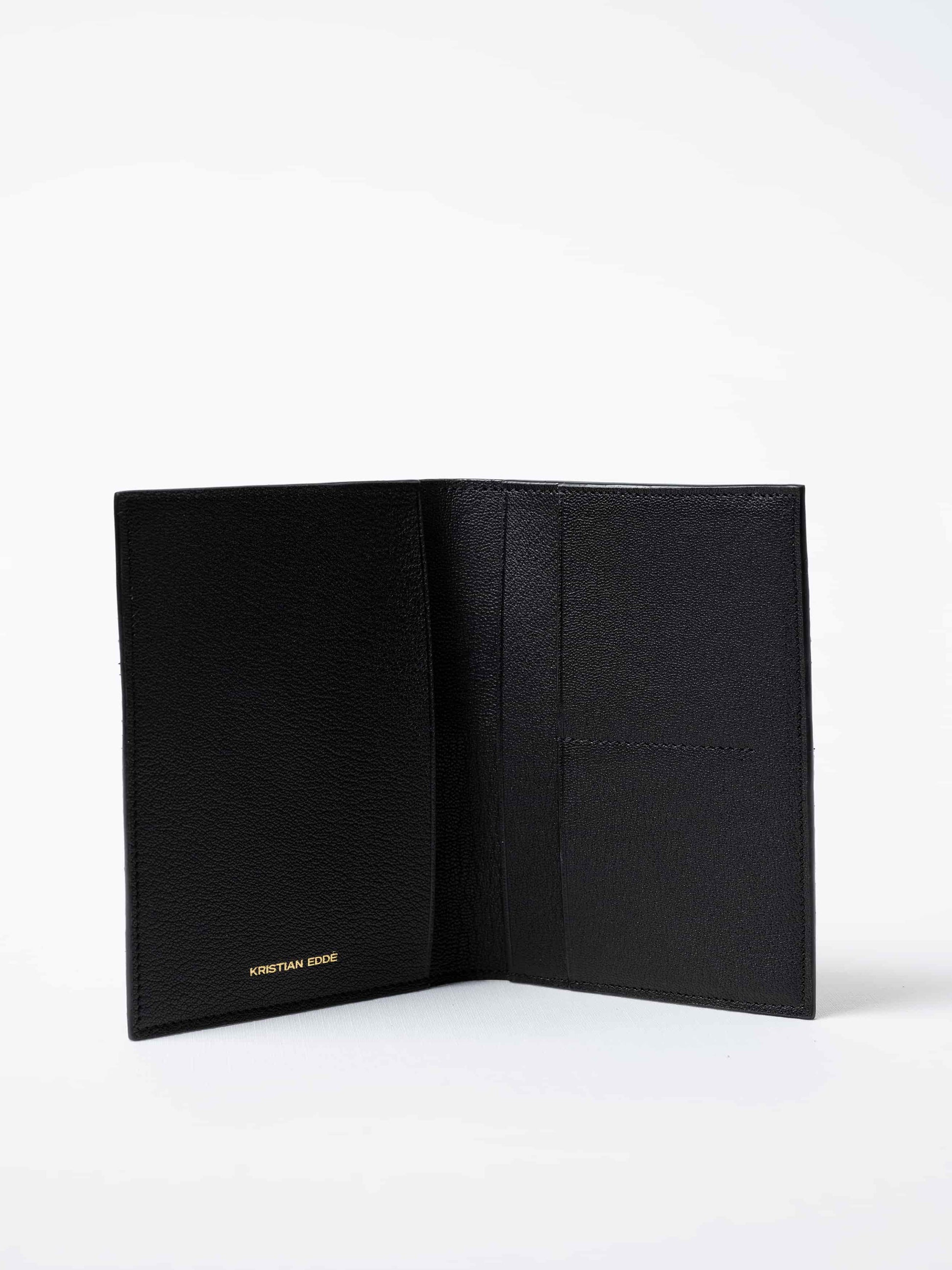Vega luxury travel wallet in black salmon leather, fully open to show interior compartments and the golden logo, sustainable luxury by Kristian Eddé