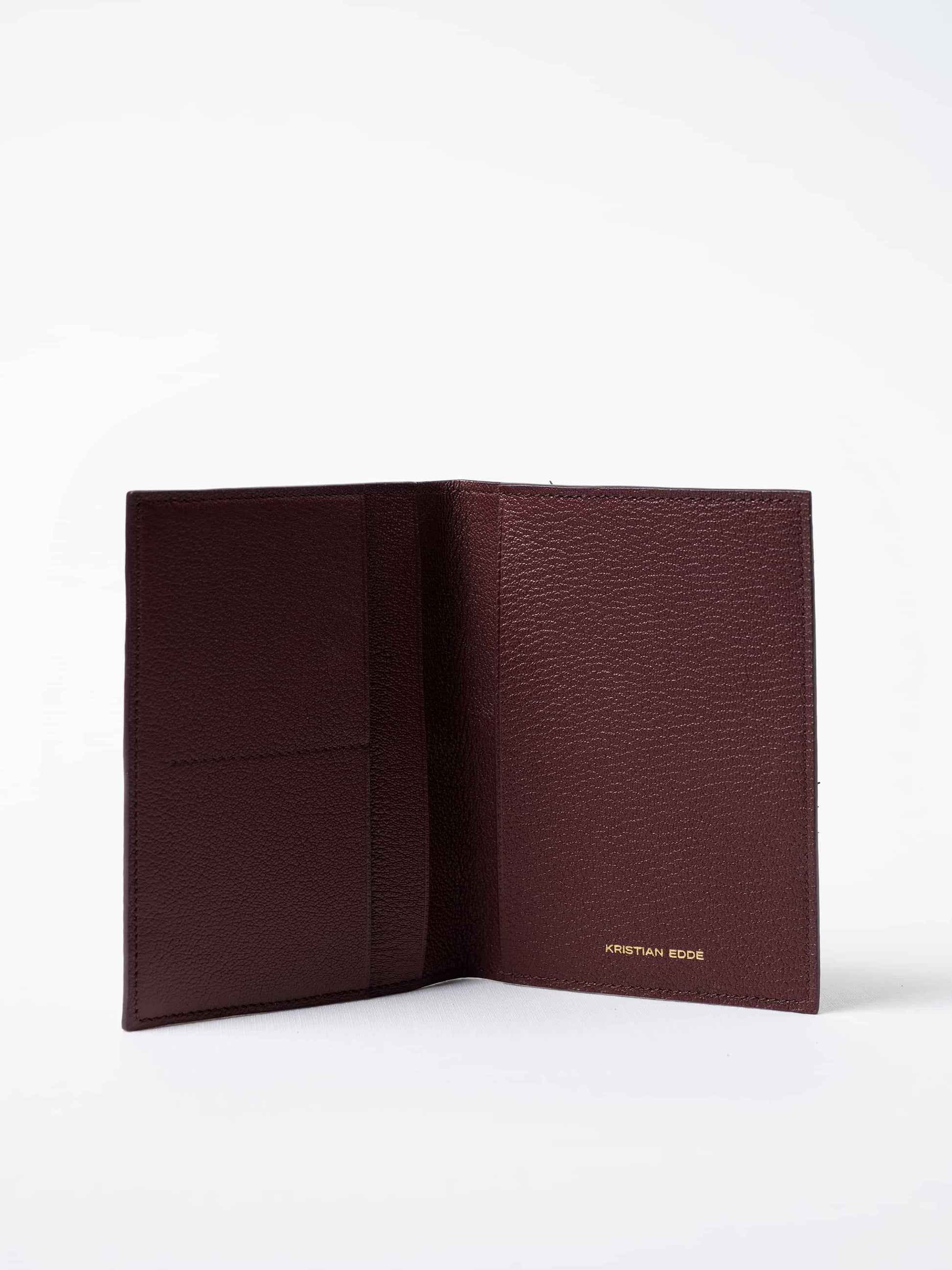 Vega luxury travel wallet in burgundy fish leather, fully open to show interior compartments, sustainable luxury by Kristian Eddé
