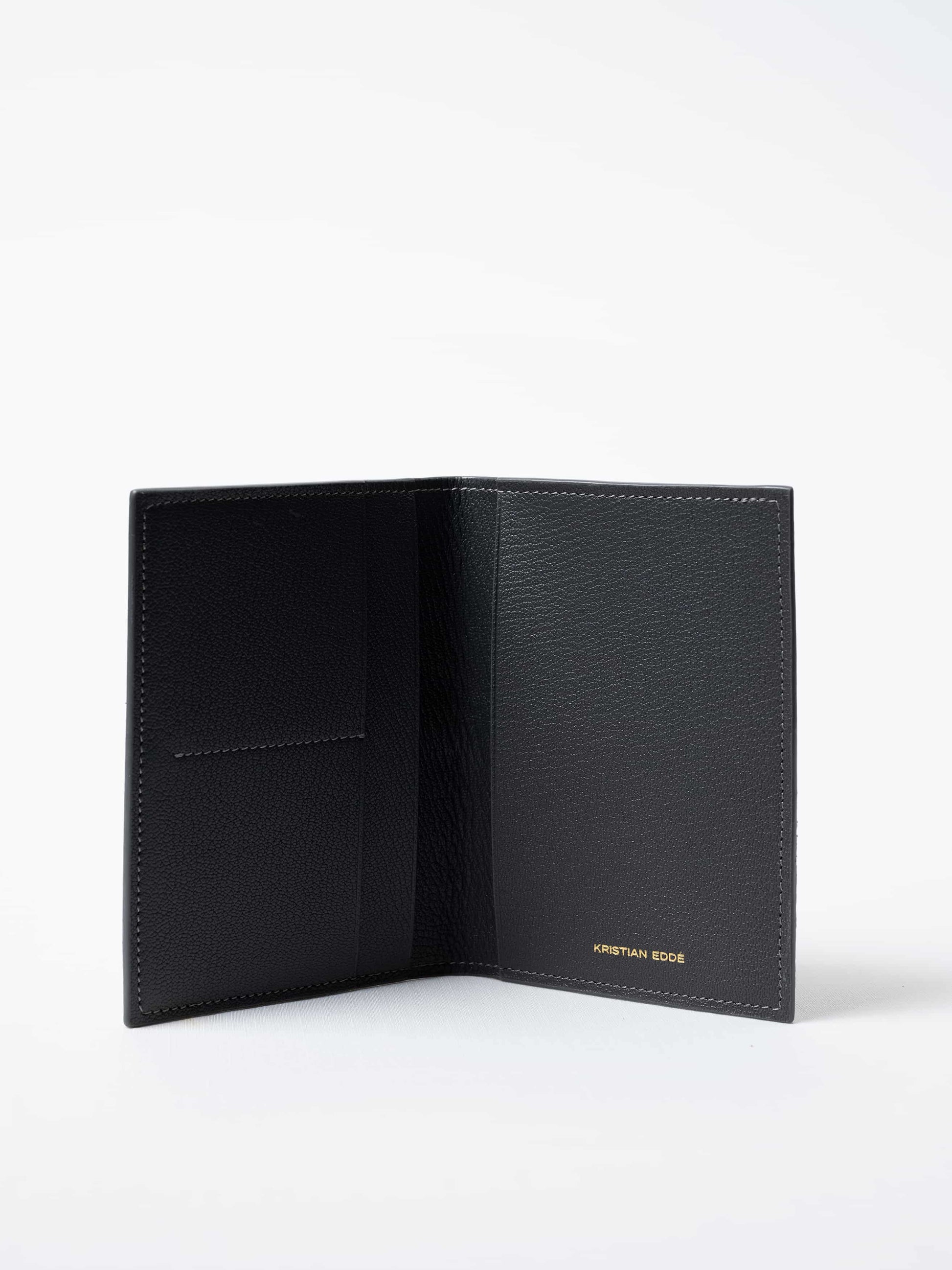 Vega Fold Passport Holder in gray fish leather, fully open to show interior compartments and gold logo, sustainable luxury by Kristian Eddé
