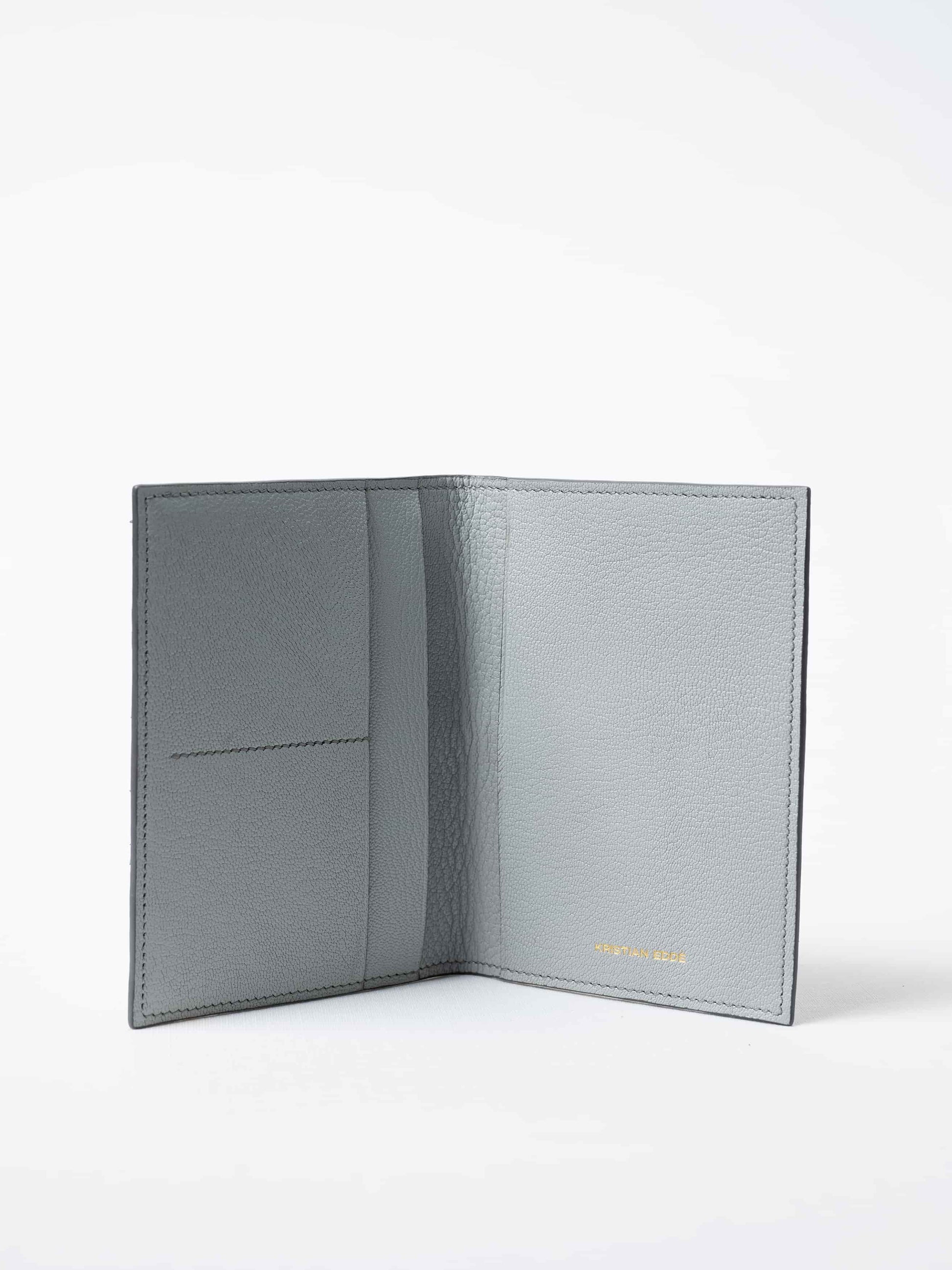 Vega Fold Passport Holder in himalayan gray fish leather and vegetable tanned goat leather interior, fully open to show interior compartments, sustainable luxury by Kristian Eddé
