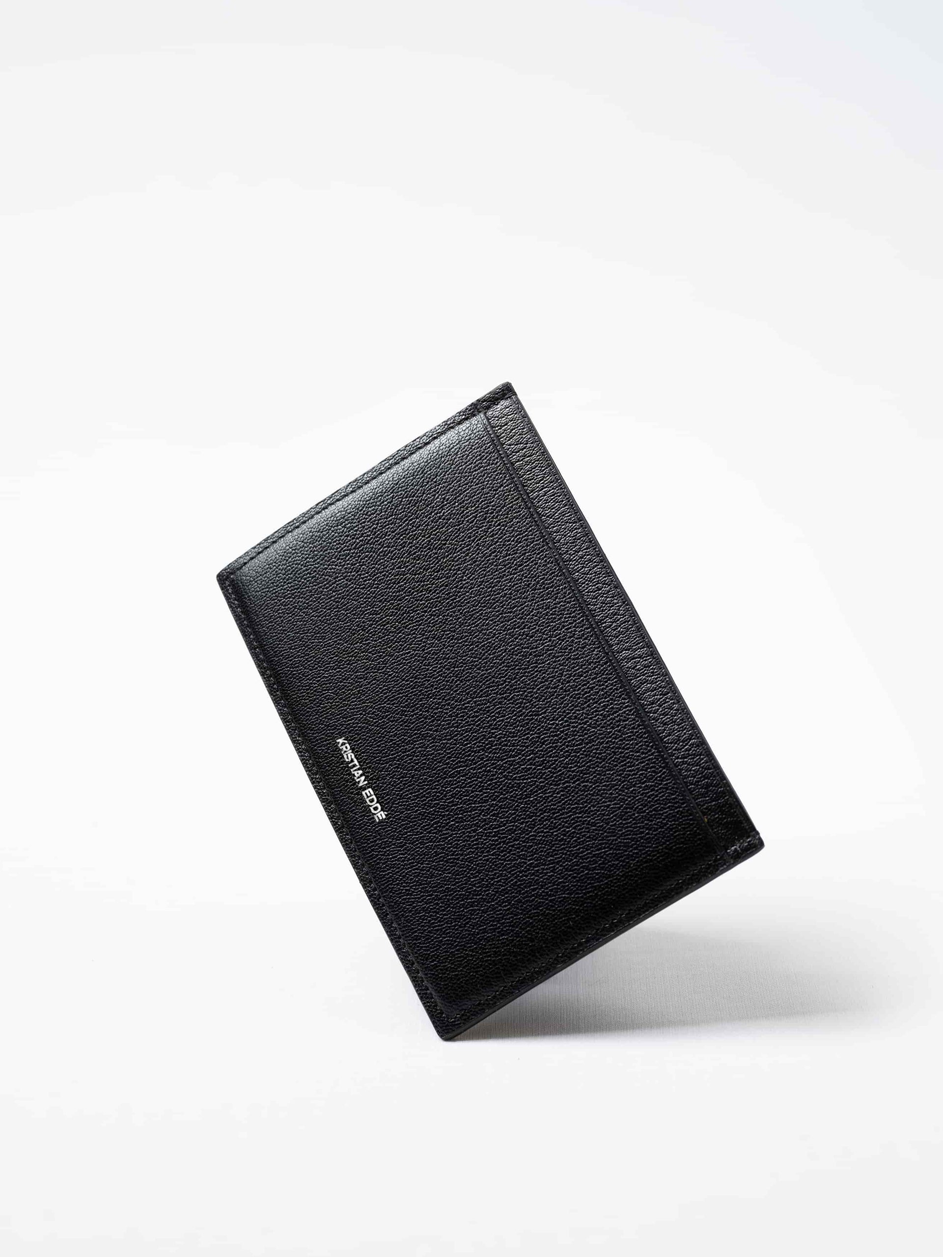Black Aurora travel wallet in salmon leather with silver logo. Handcrafted in Stockholm, this luxury accessory elevates passports, cards, and travel style