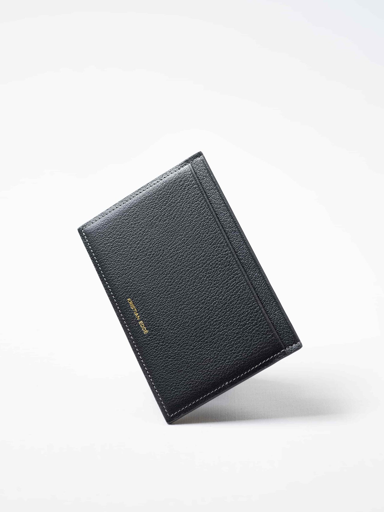 Gray Aurora travel wallet in fish leather with gold logo. Handcrafted in Stockholm, this luxury accessory elevates passports, cards, and travel style