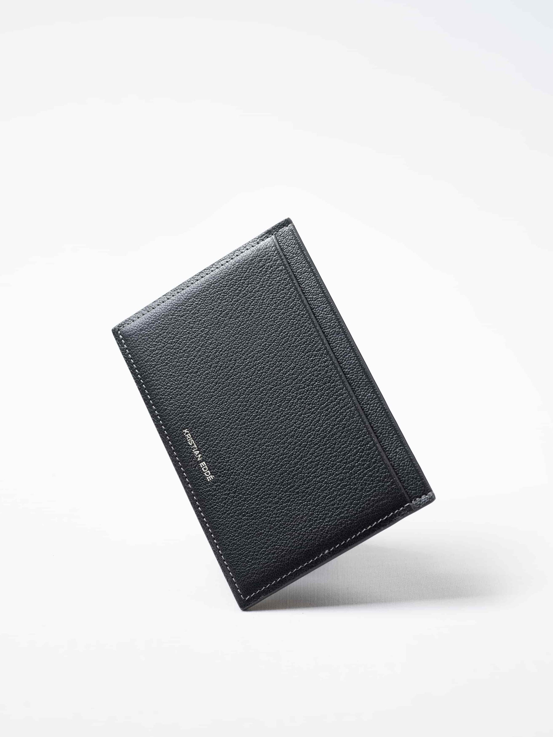 Gray Aurora travel wallet in fish leather with silver logo. Handcrafted in Stockholm, this luxury accessory elevates passports, cards, and travel style