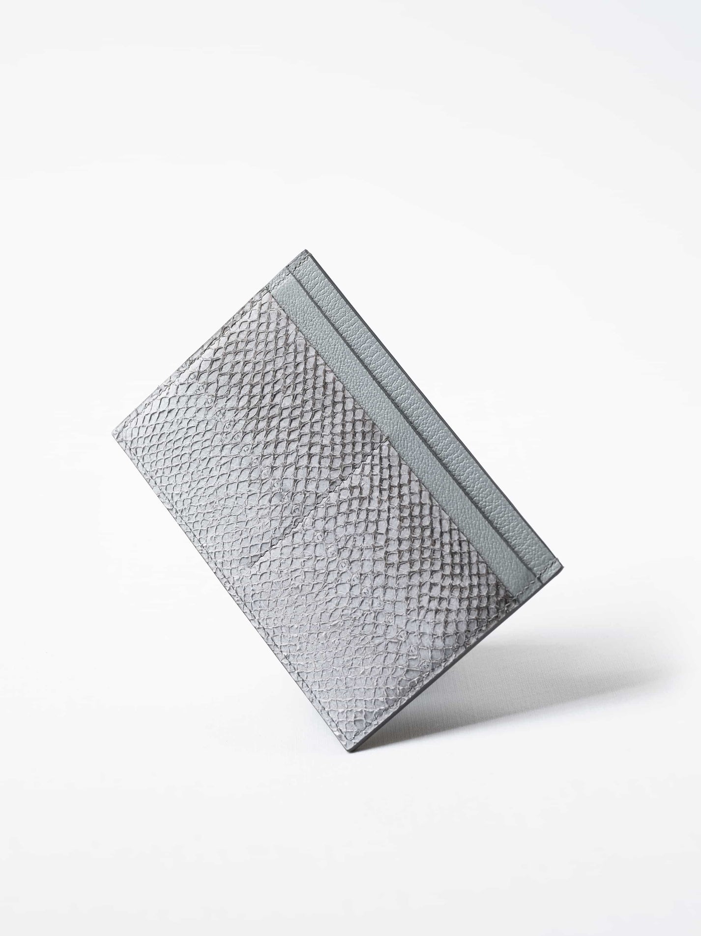 Discover the himalayan gray Aurora travel wallet, handcrafted in sustainable salmon leather. A luxury accessory designed for passports, cards, and modern journeys