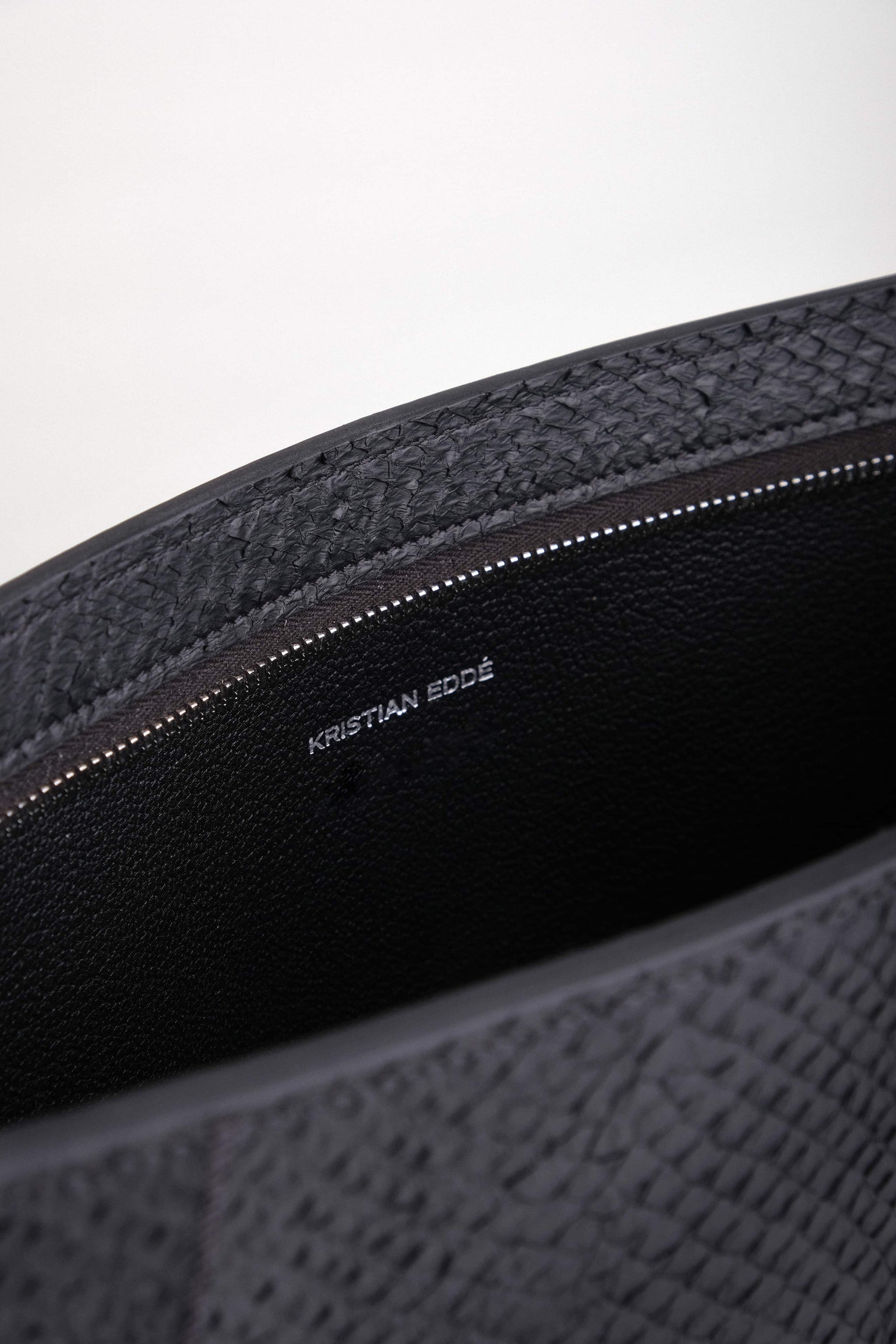 Open Baltic Clutch revealing interior lining in vegetable-tanned French goat leather and spacious compartment for a 14” laptop