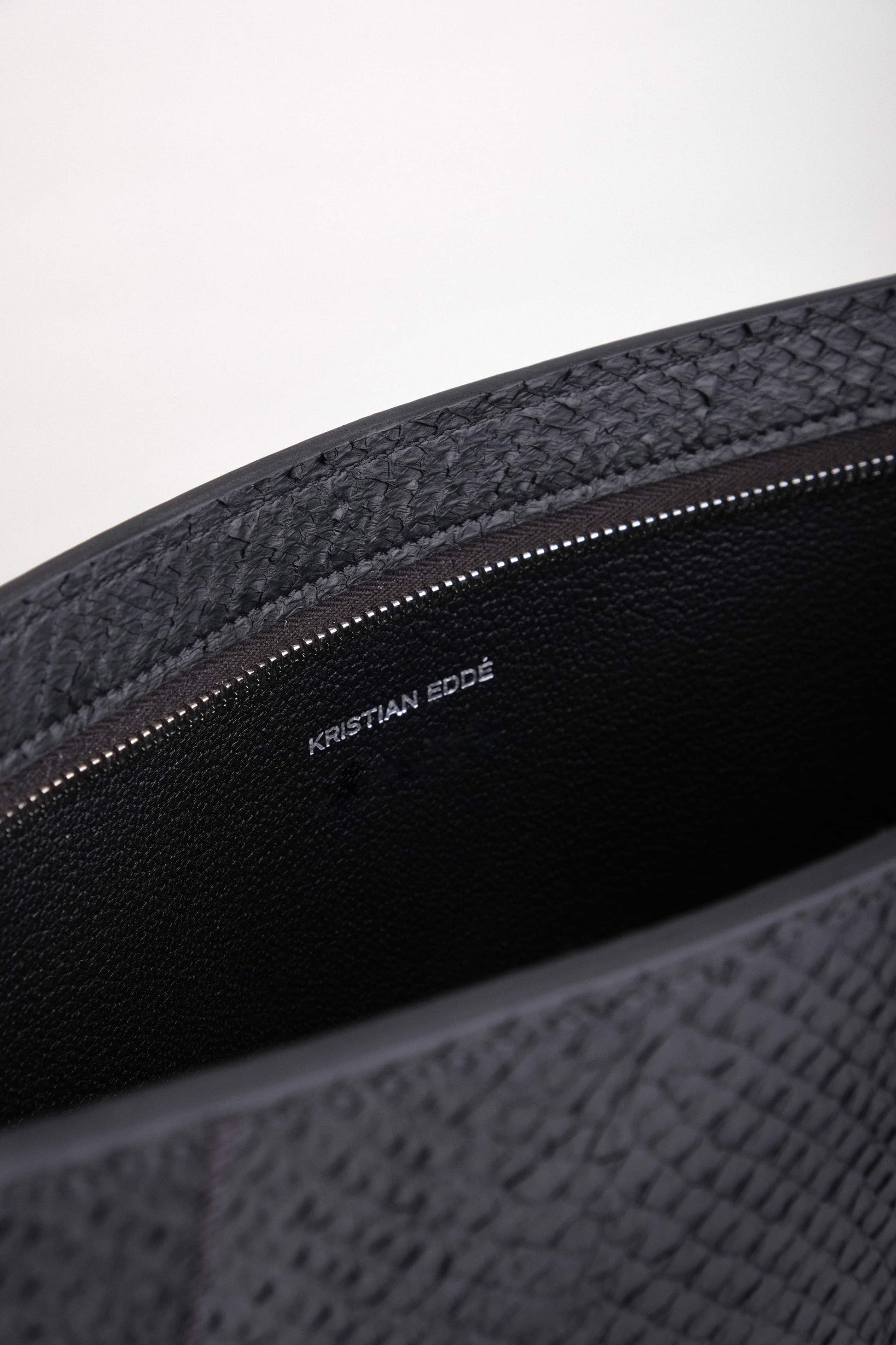 Open Baltic Clutch revealing interior lining in vegetable-tanned French goat leather and spacious compartment for a 14” laptop