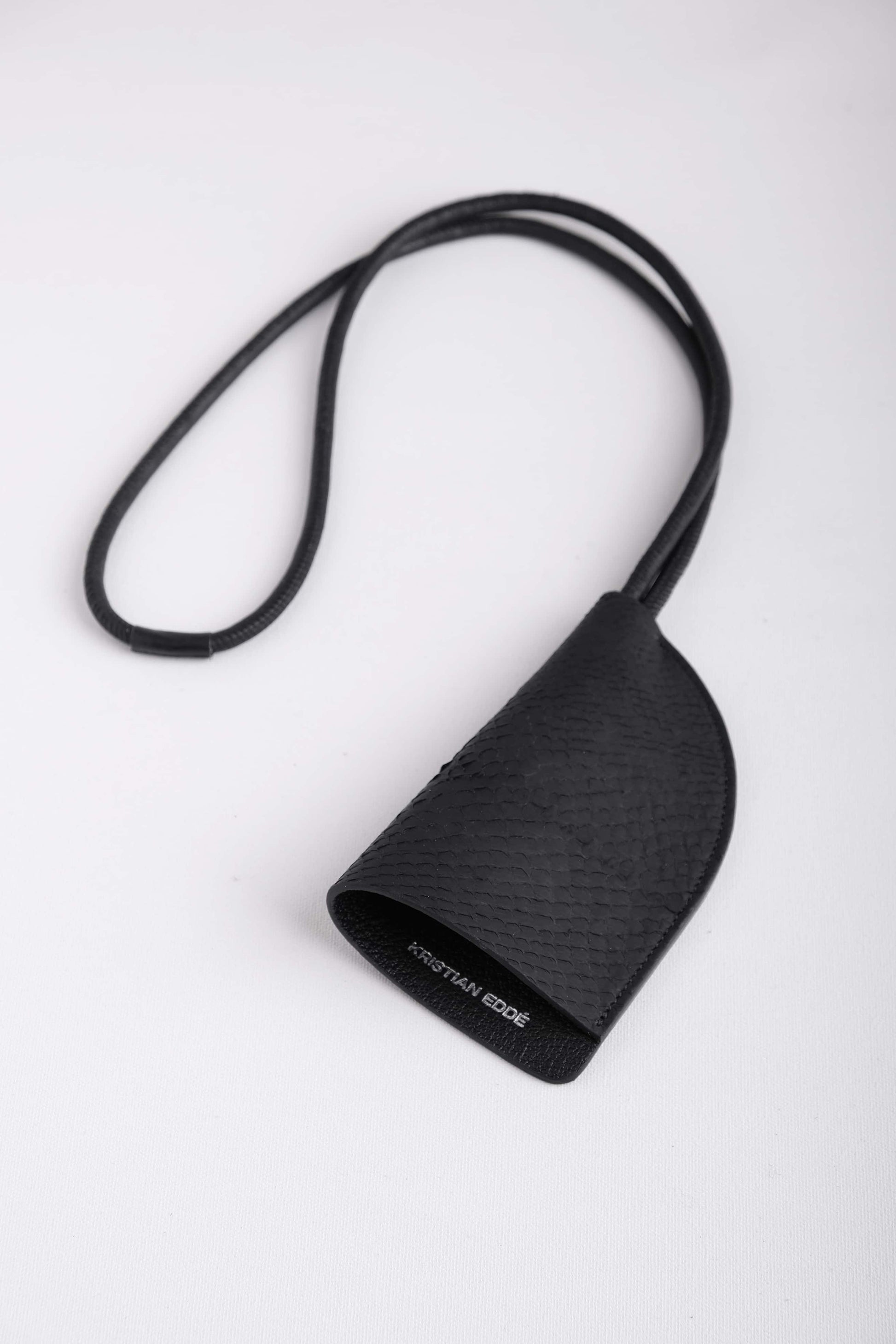 Front view of Fjord black fish leather round neck keychain with leather cord strap