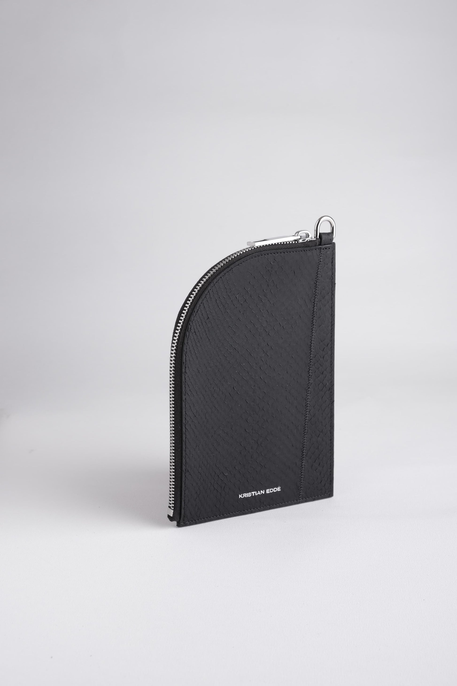 Nord zipper pouch in arctic black fish leather, front view of sustainable luxury accessory by Kristian Eddé