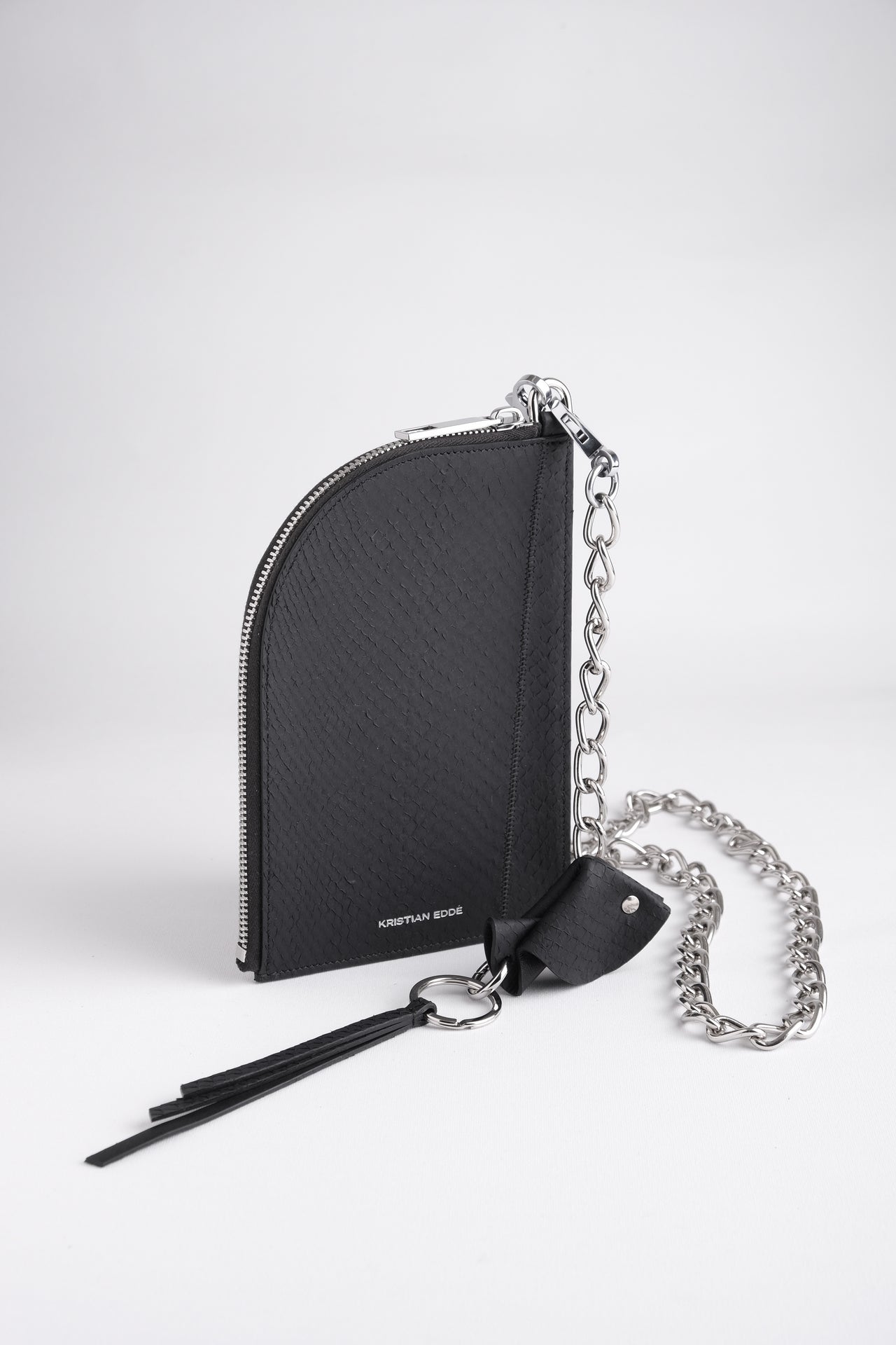 Nord zipper pouch on chain in arctic black salmon leather with a fish key charm, front view on white background