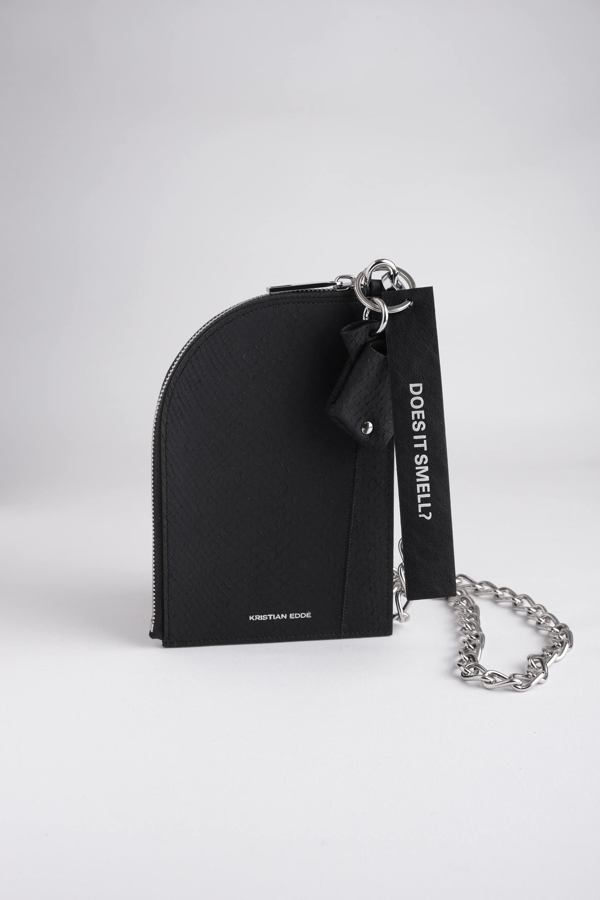 Nord salmon leather pouch with silver chain and fish key charm and key ring, arctic black, front view by Kristian Eddé