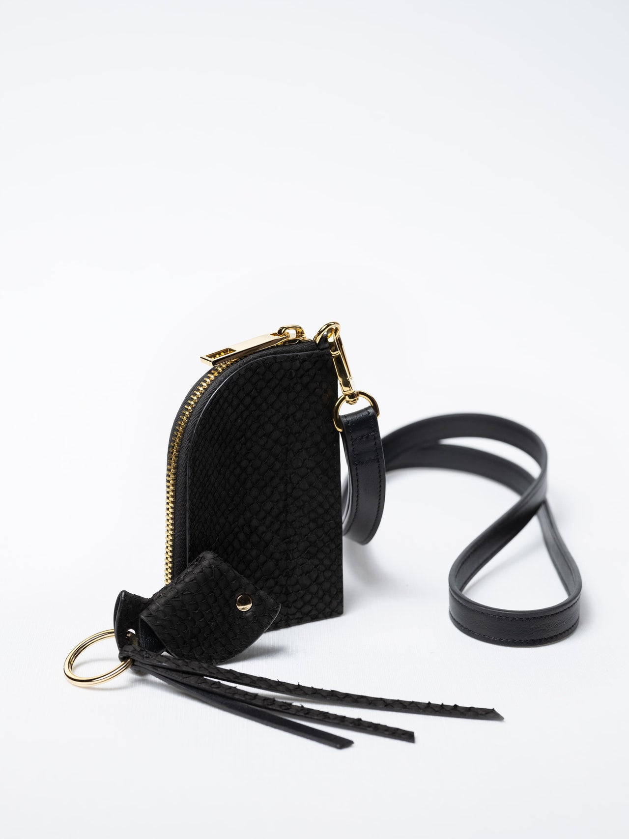 Salma zipper wallet on strap in black fish leather with gold zipper and key charm – sustainable luxury by Kristian Eddé