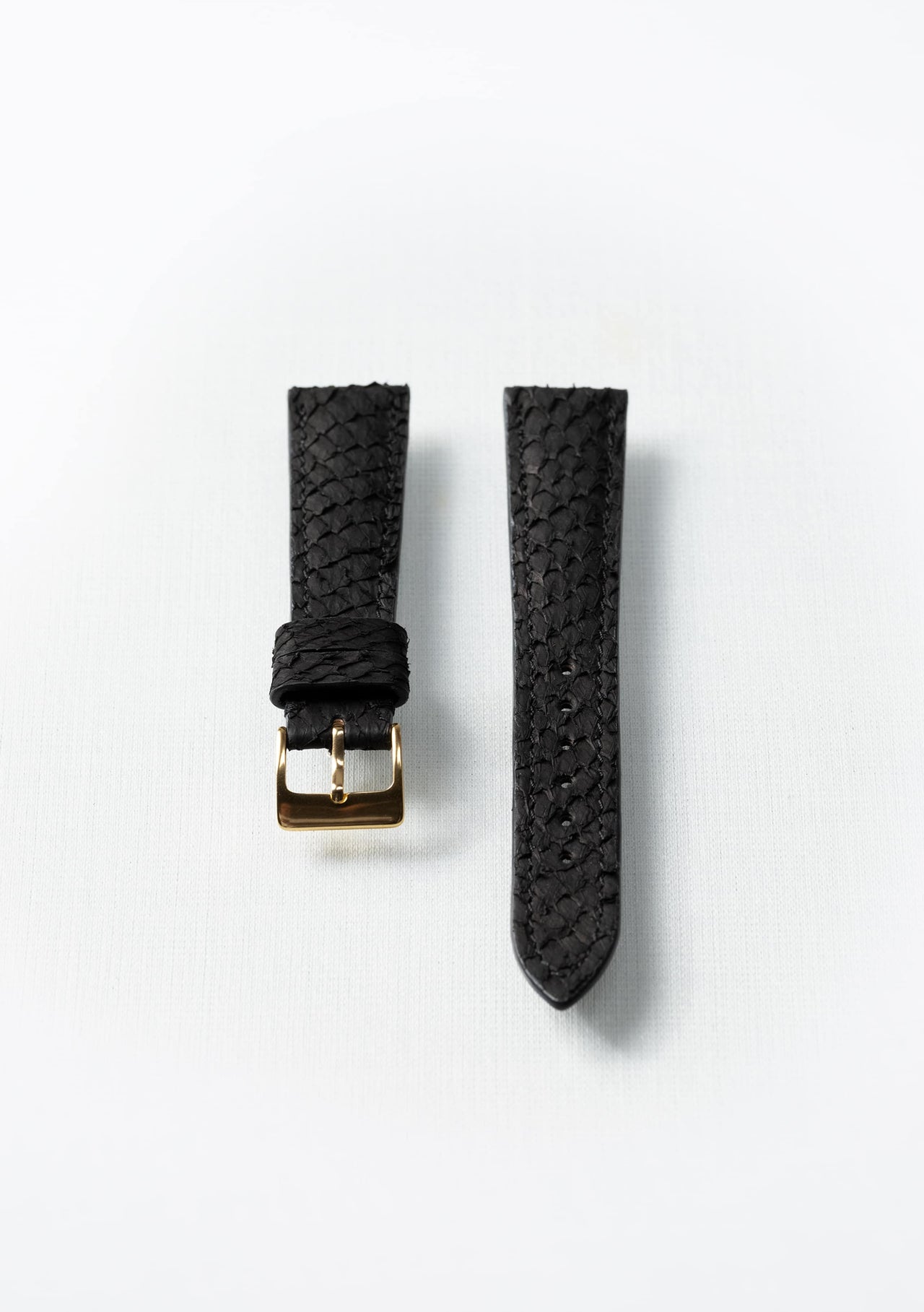 Black fish leather watch strap with gold buckle, sustainable luxury accessory by Kristian Eddé