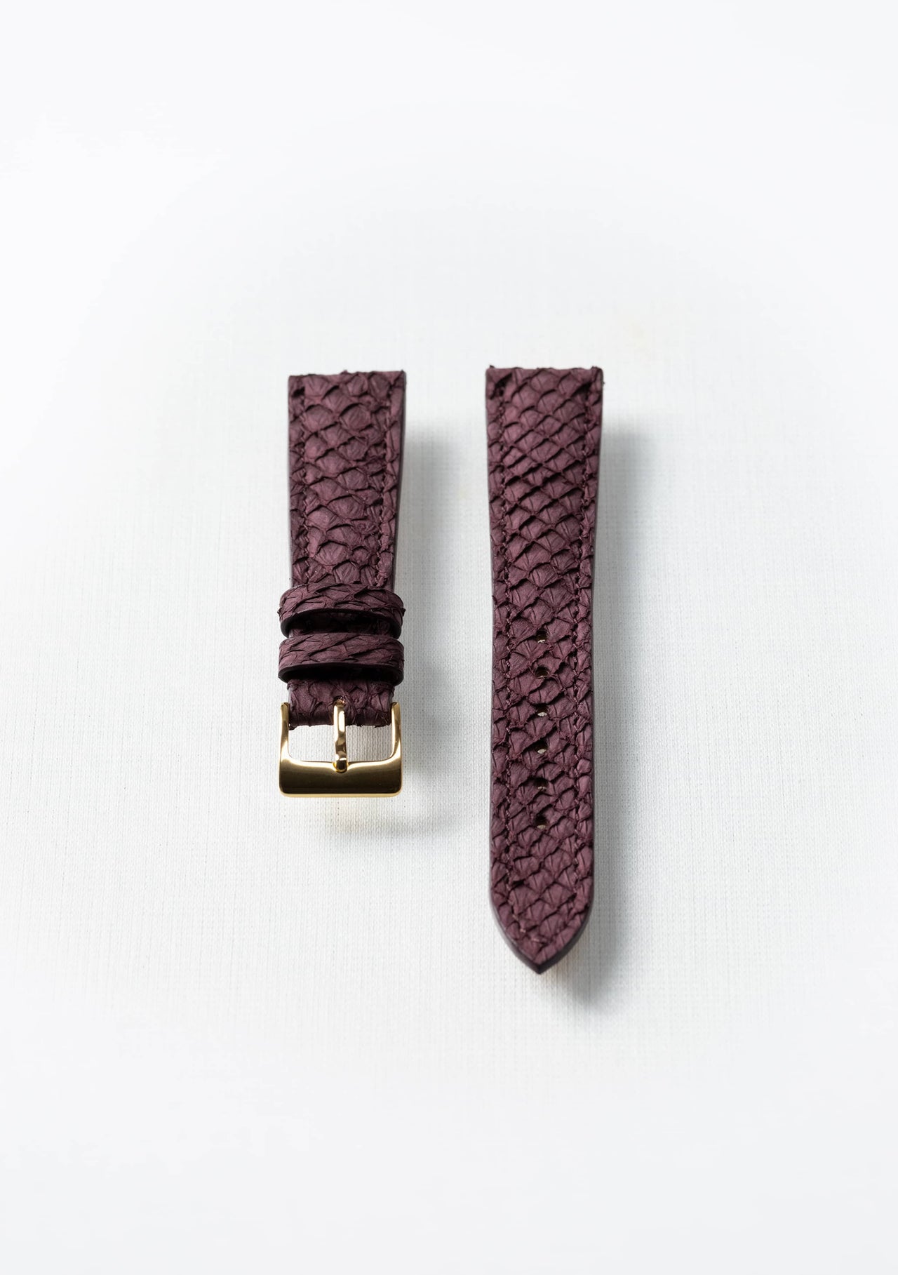 Burgundy salmon leather watch strap with gold buckle, handcrafted sustainable accessory by Kristian Eddé