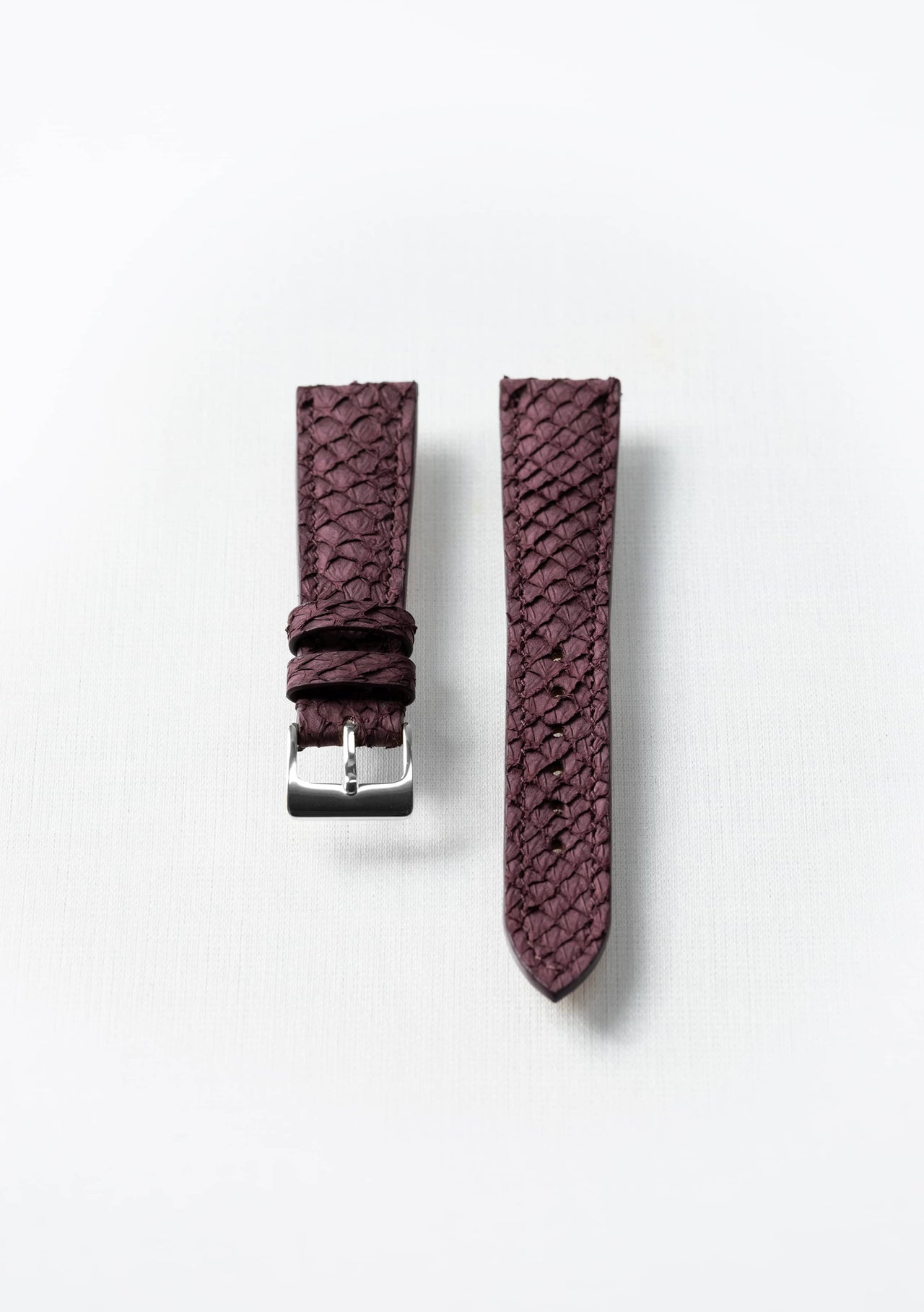 Burgundy fish leather watch strap with gold buckle, sustainable luxury accessory by Kristian Eddé