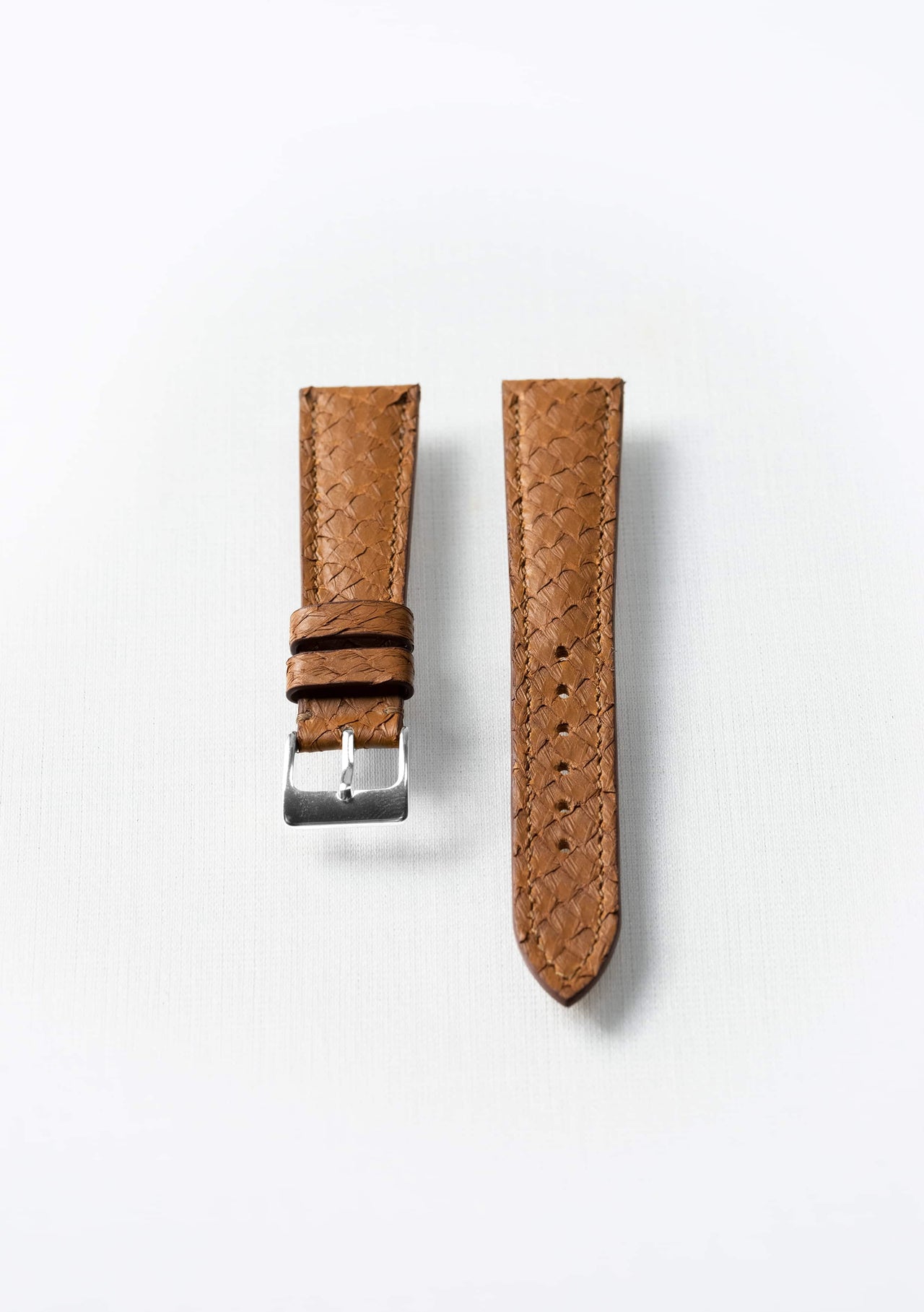 Cognac brown fish leather watch strap with silver buckle, sustainable luxury accessory by Kristian Eddé