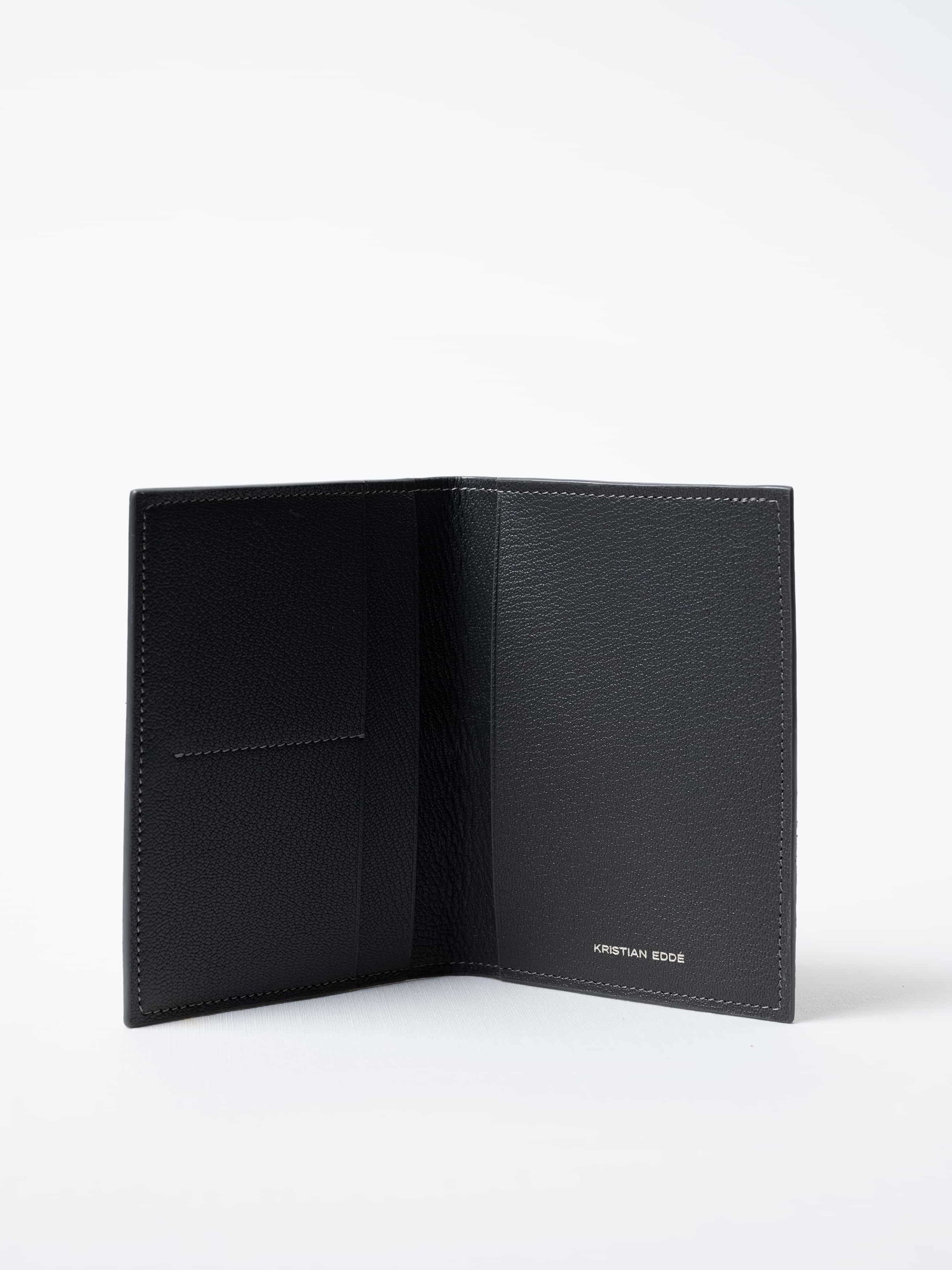 Vega luxury travel wallet in gray fish leather, fully open to show interior compartments and silver logo, sustainable luxury by Kristian Eddé

