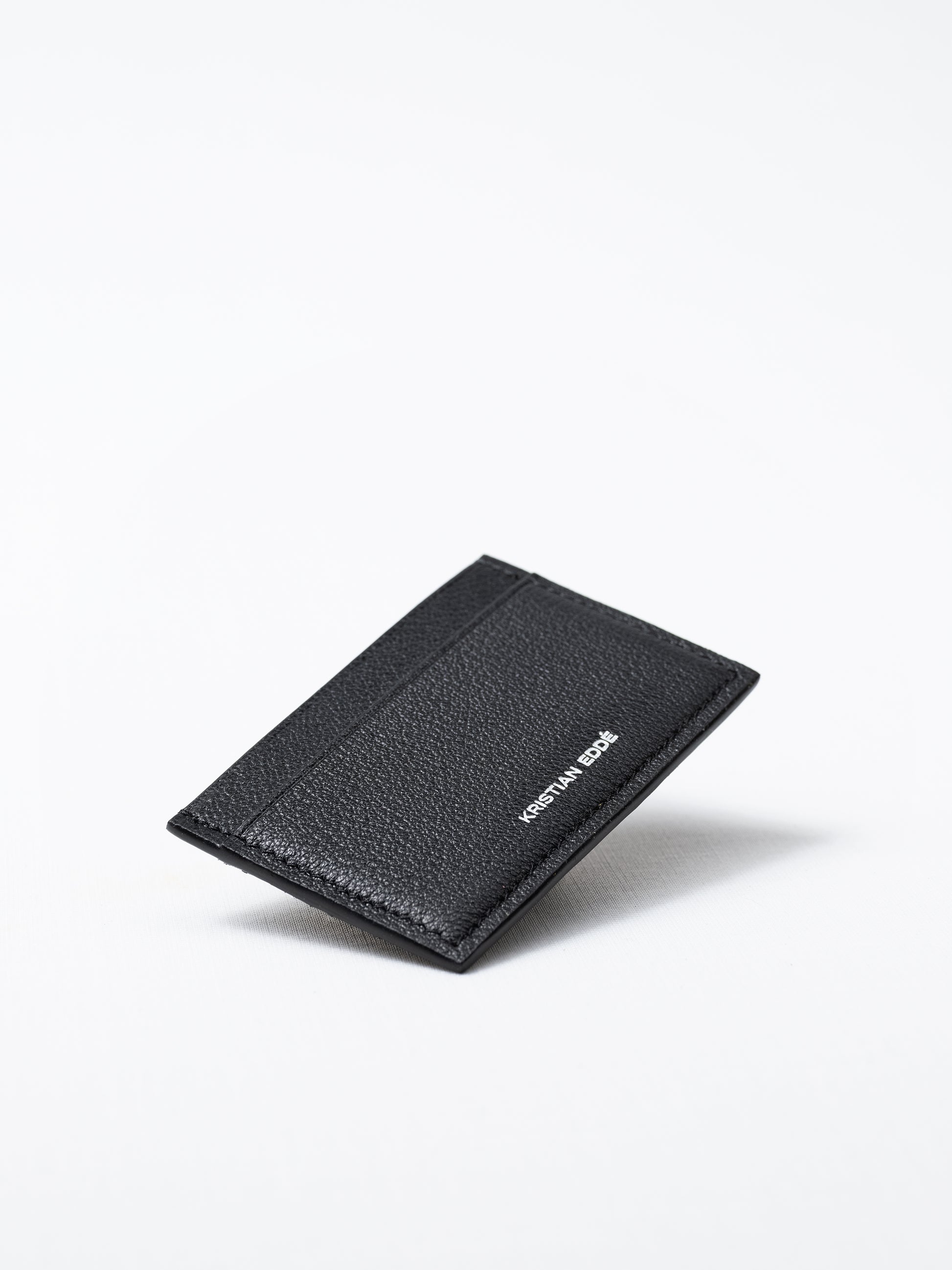 Bothnia black card holder made of salmon leather, back view of silver logo on white background