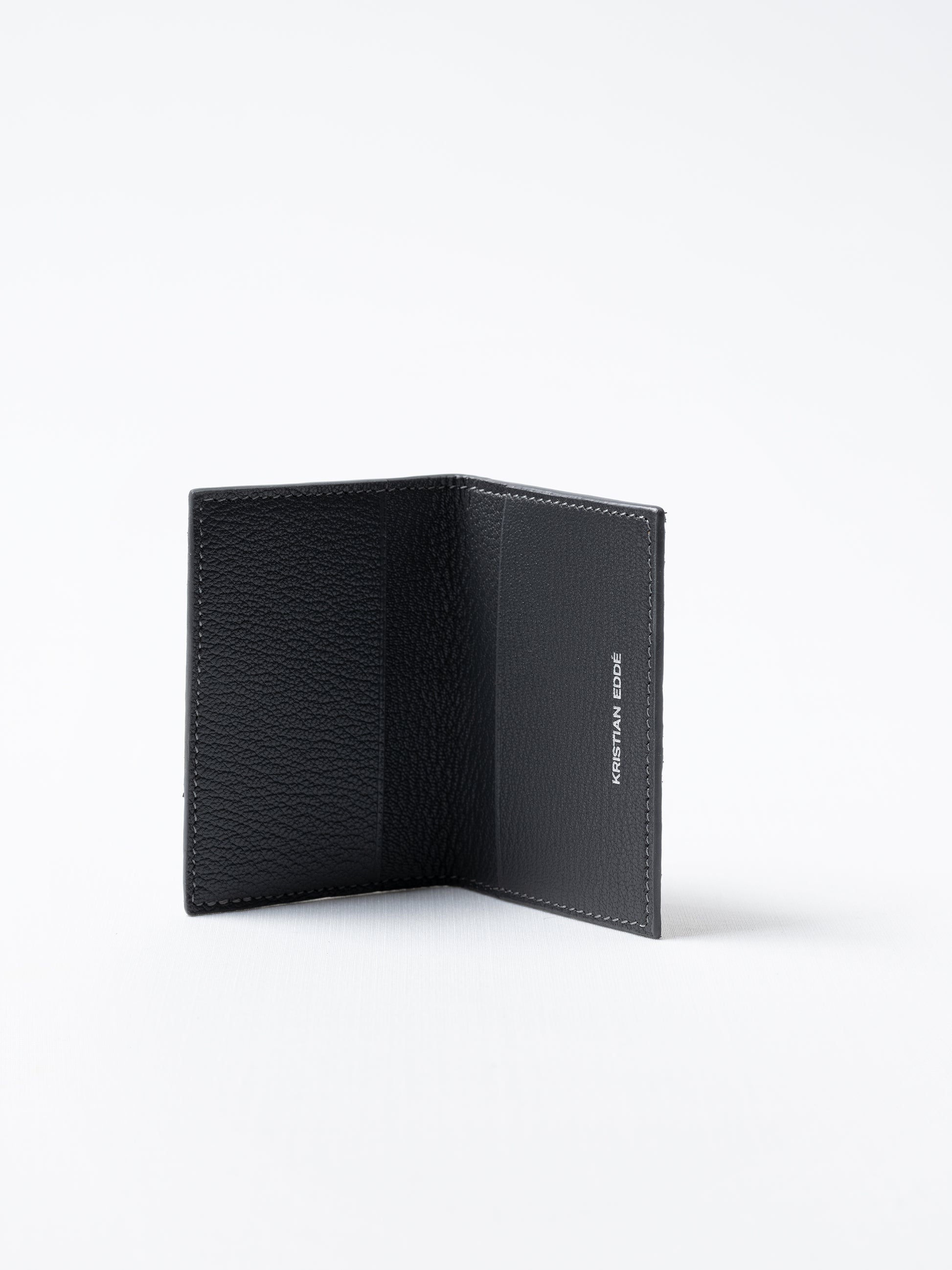 Barents cardholder made of  gray salmon leather with silver logo, open view showing card slots
