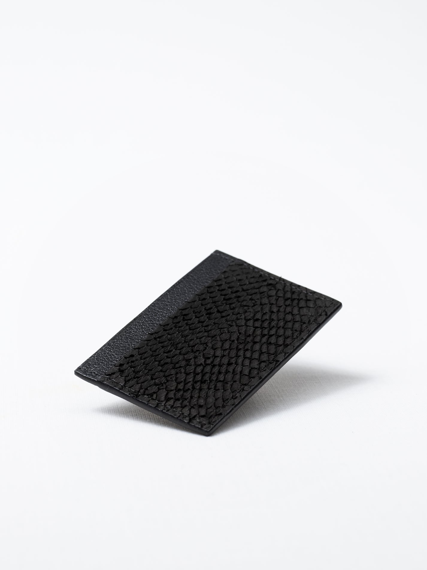 Bothnia black card holder made of salmon leather, front view on white background