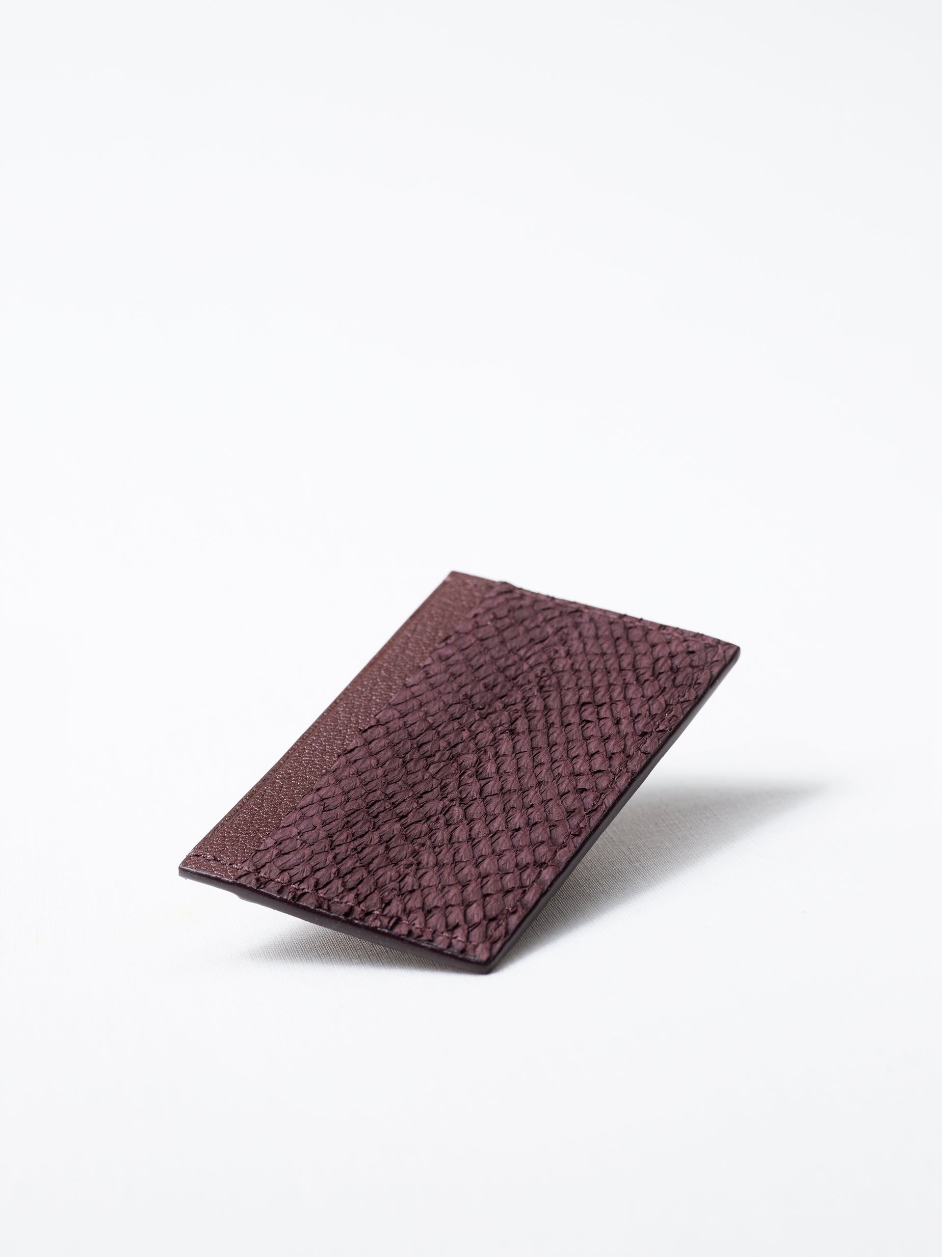 Bothnia burgundy card holder made of salmon leather, front view on white background