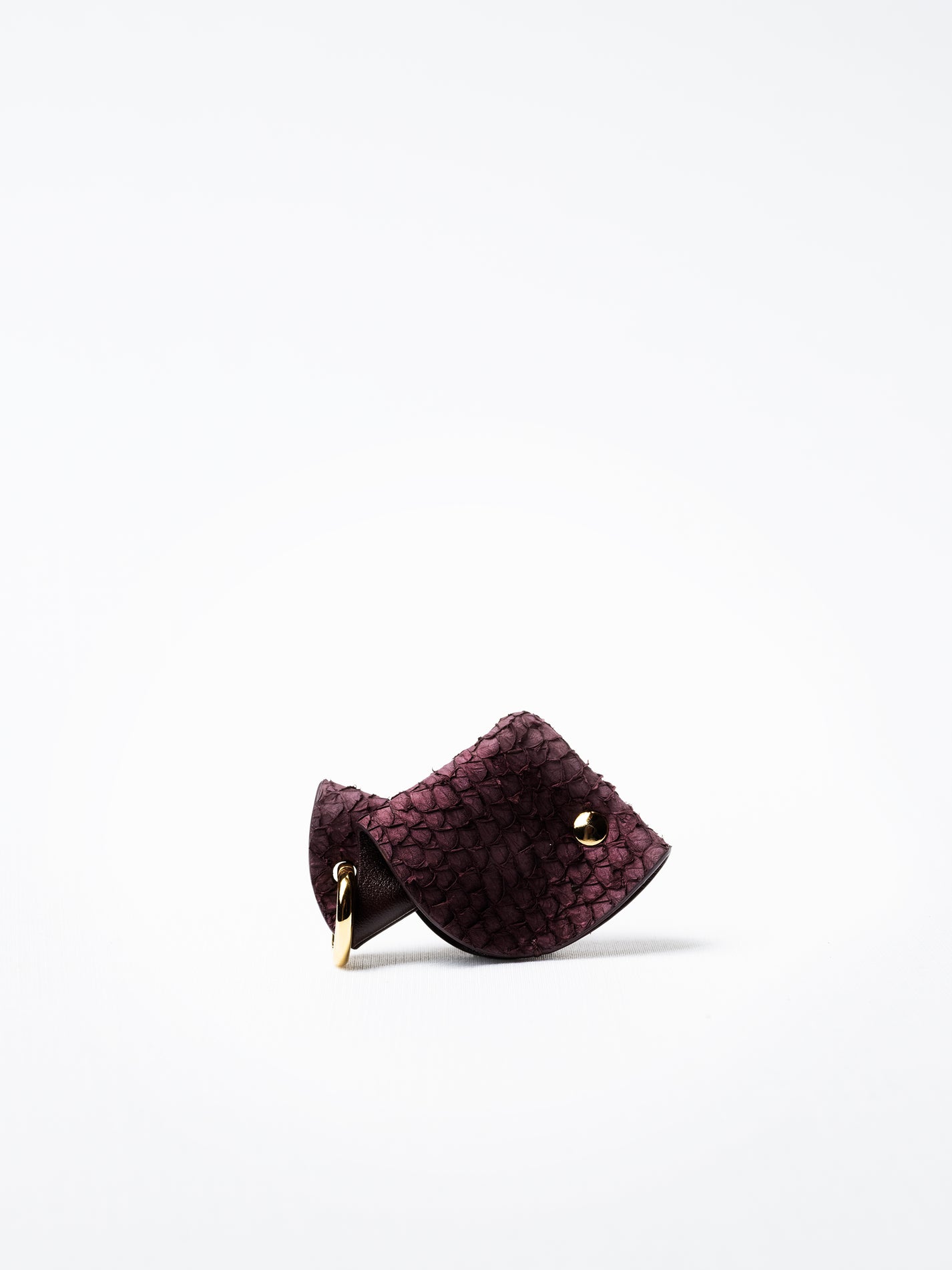 Fish key charm in burgundy Scandinavian salmon leather, front view showing natural sea-inspired grain
