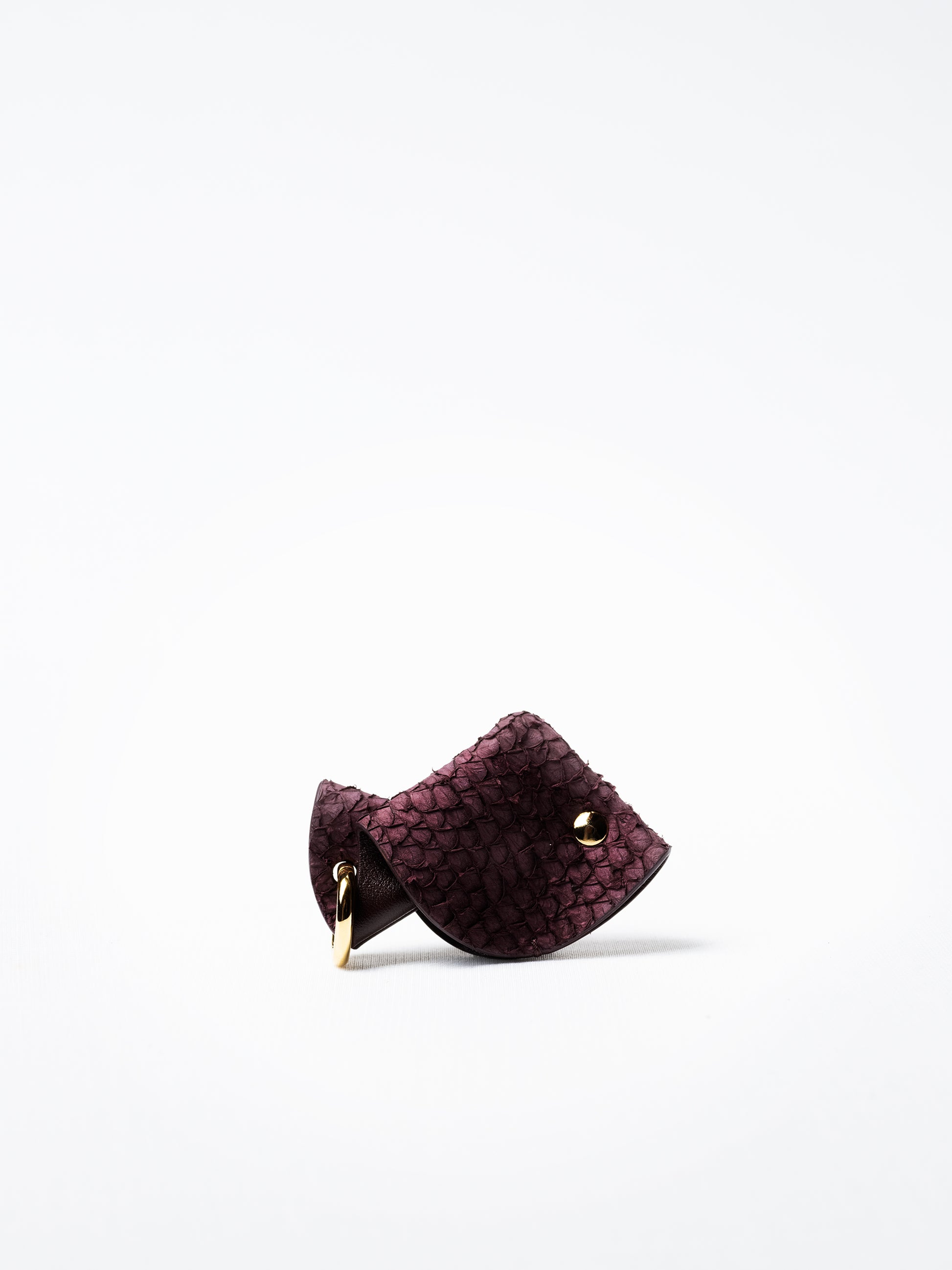 Fish key charm in burgundy Scandinavian salmon leather, front view showing natural sea-inspired grain