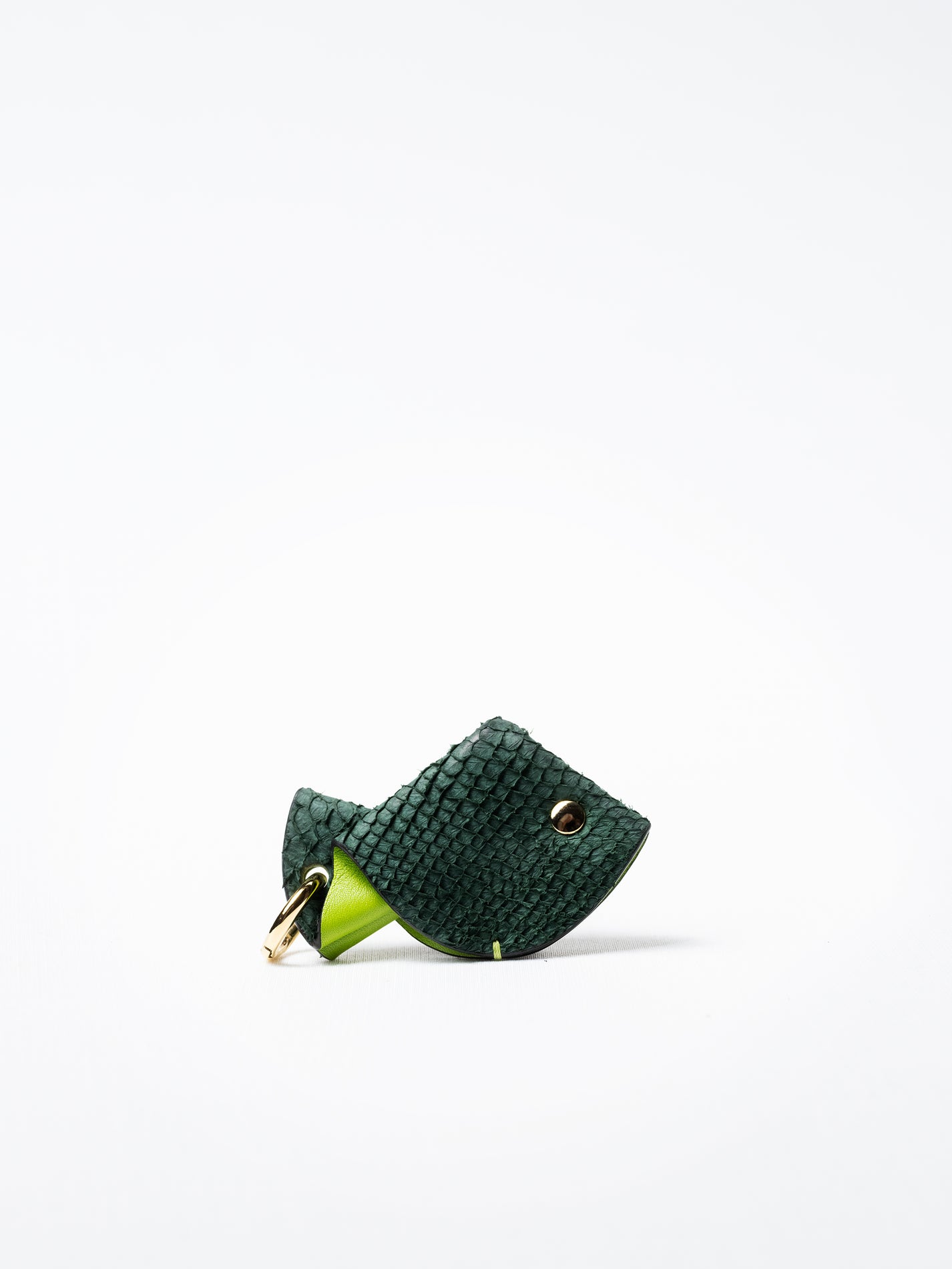 Fish key charm in green salmon leather, shown with gold-plated key ring and clasp