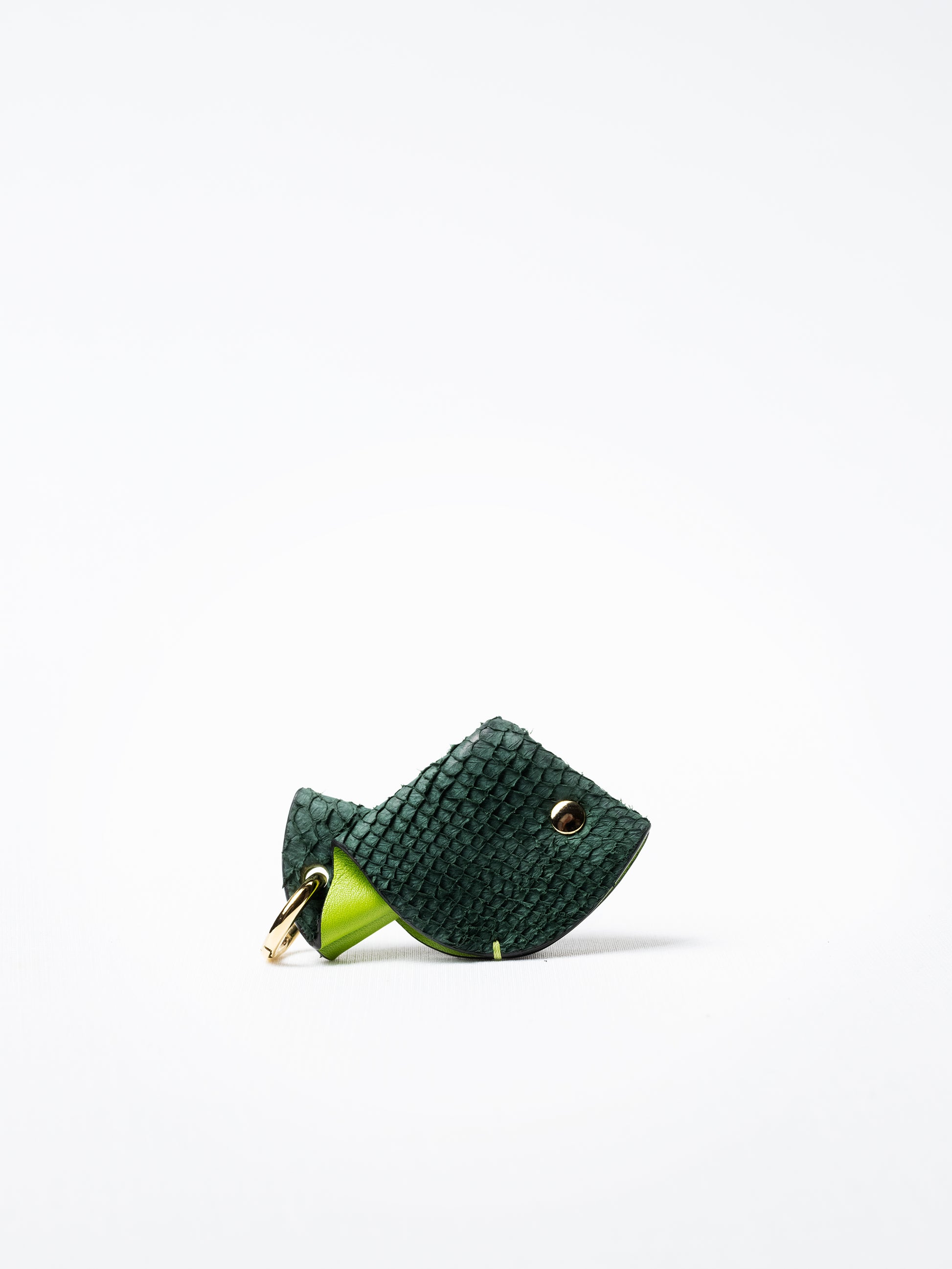 Fish key charm in green salmon leather, shown with gold-plated key ring and clasp