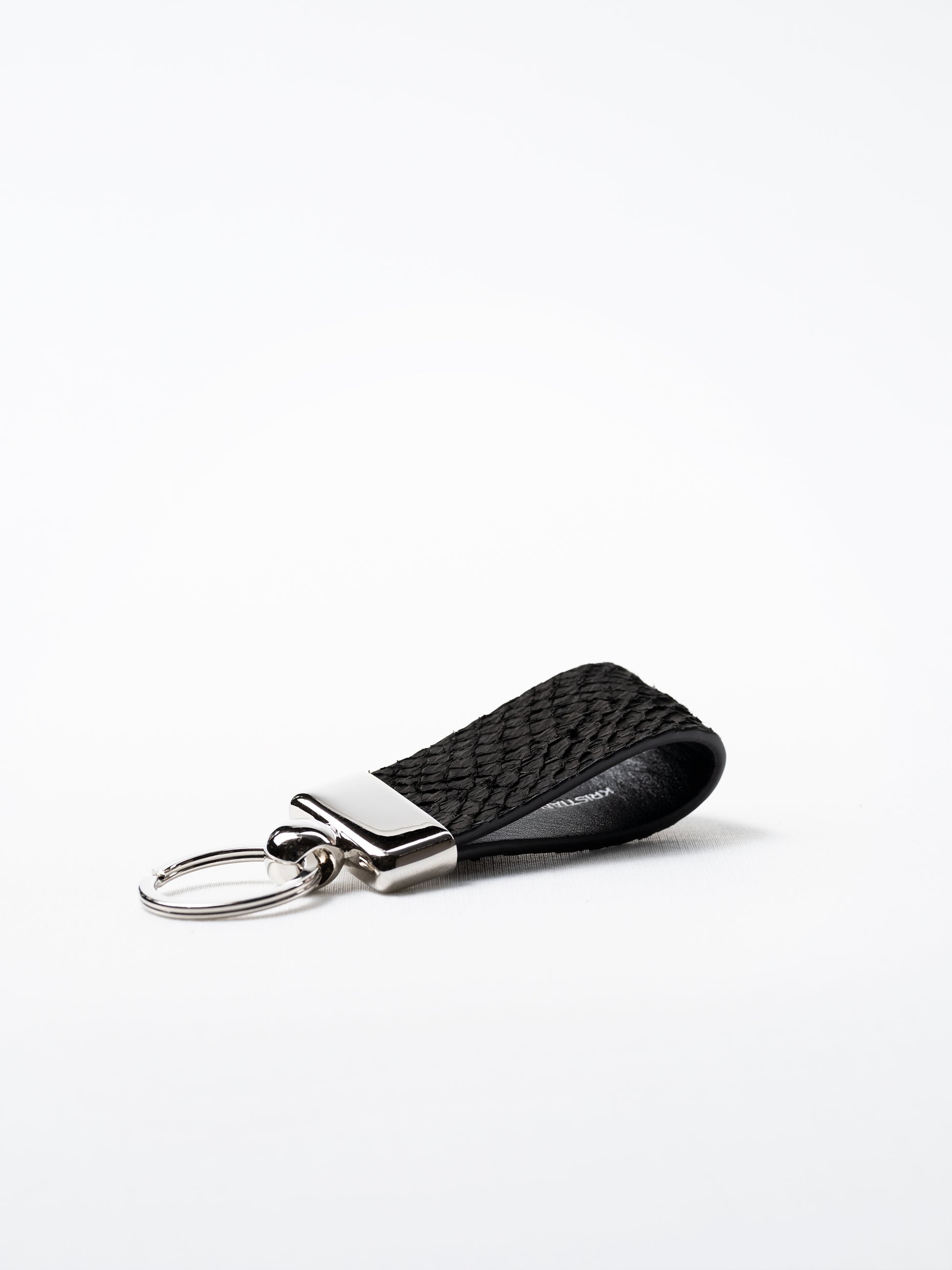 Black salmon leather key ring, side view showing natural grain and silver hardware