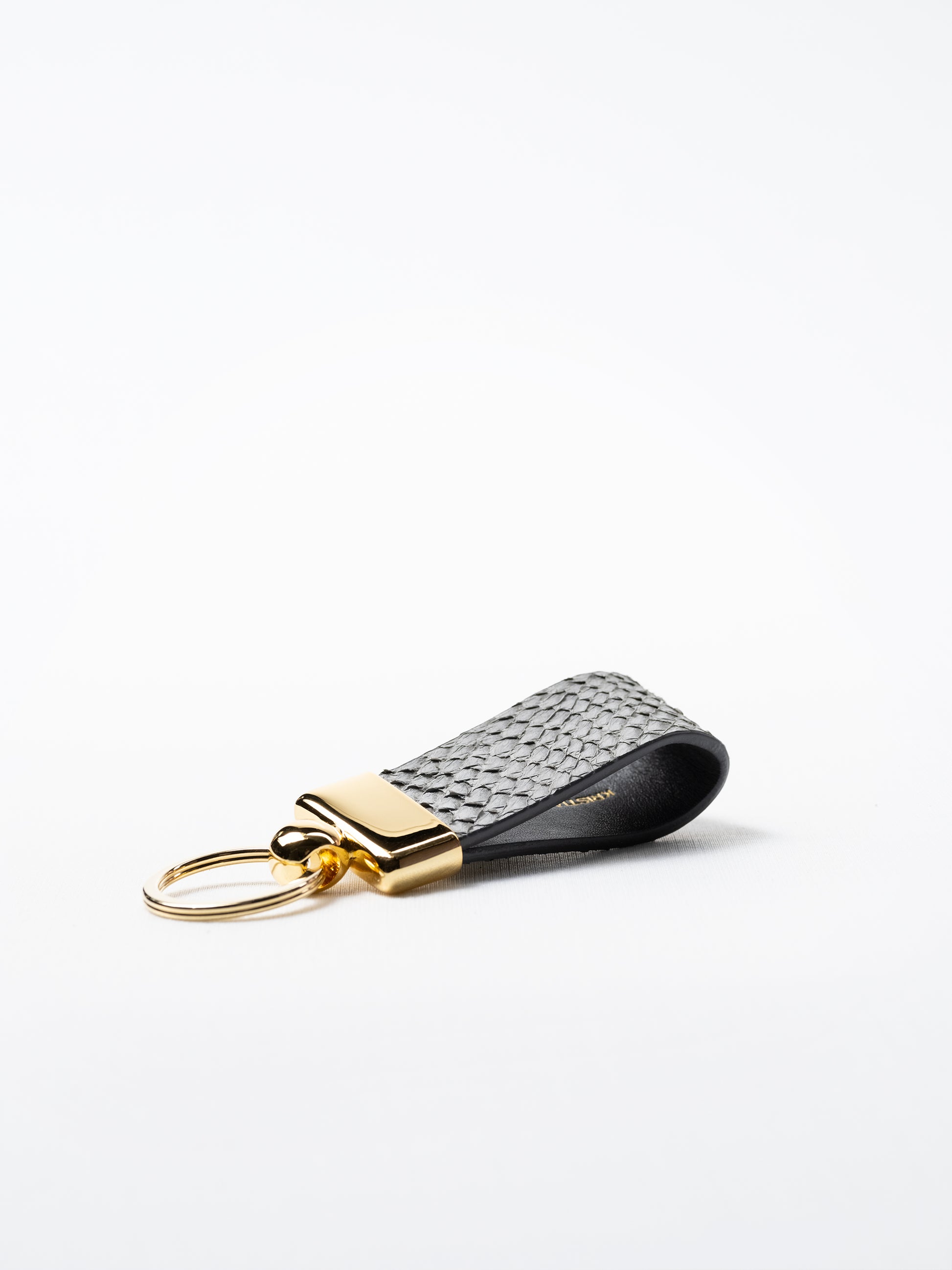 Gray salmon leather key ring, side view showing natural grain and structured loop